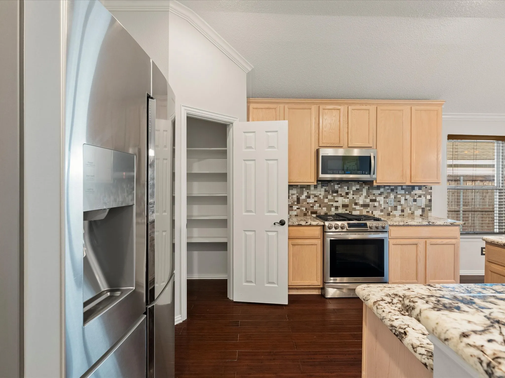 Spacious kitchen with walk in pantry wood flooring