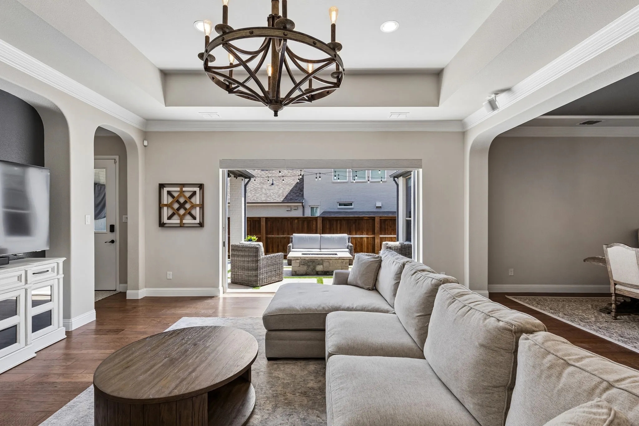 The vanishing sliding door seamlessly connects the living space to the outdoor patio, perfect for enjoying the cooler weather.
