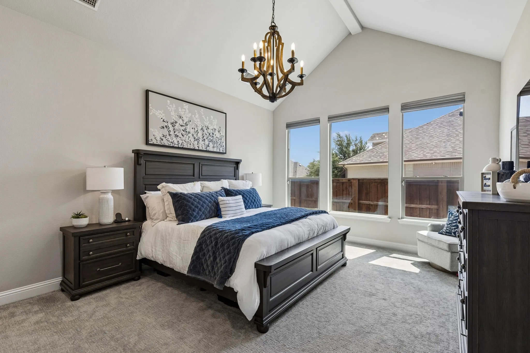 Spacious primary bedroom featuring abundant natural light and convenient electric shades.