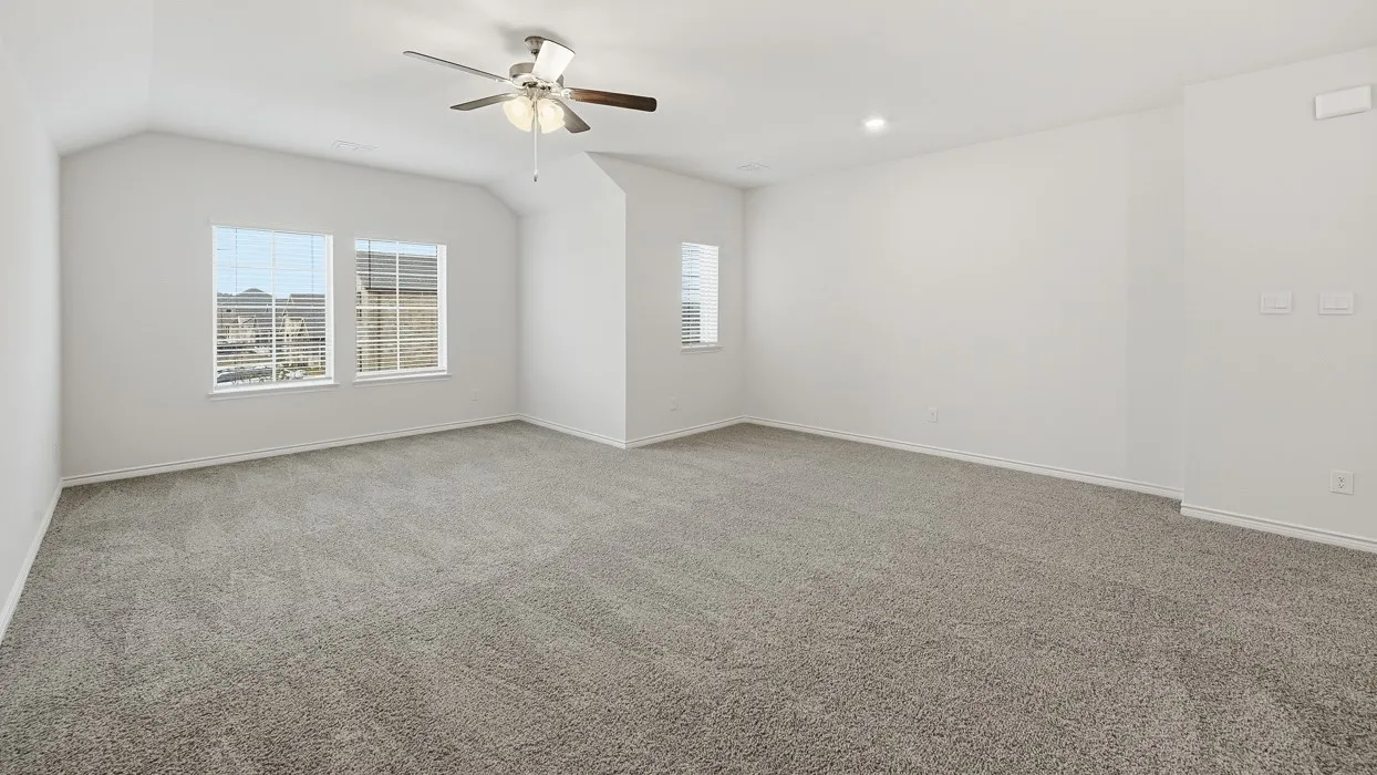 Spacious room featuring vaulted ceilings, a ceiling fan with integrated lighting, recessed lighting, and grey carpeting