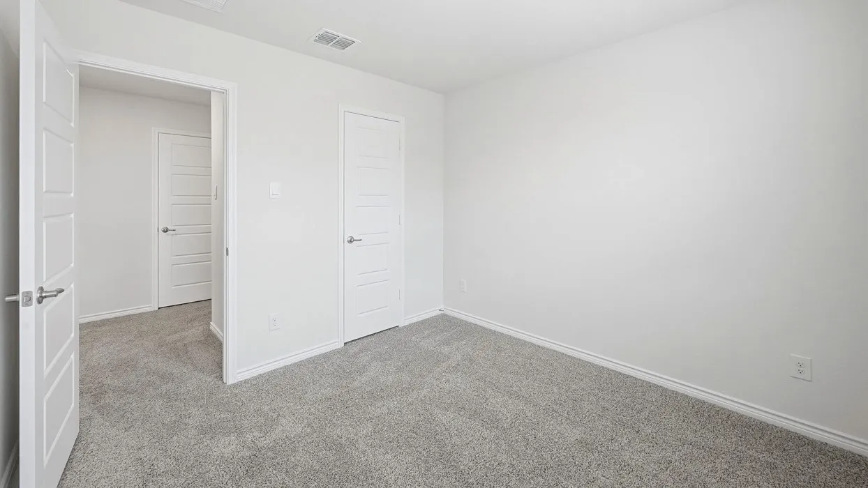 Carpeted room with white walls, white trim, and white five-panel interior doors