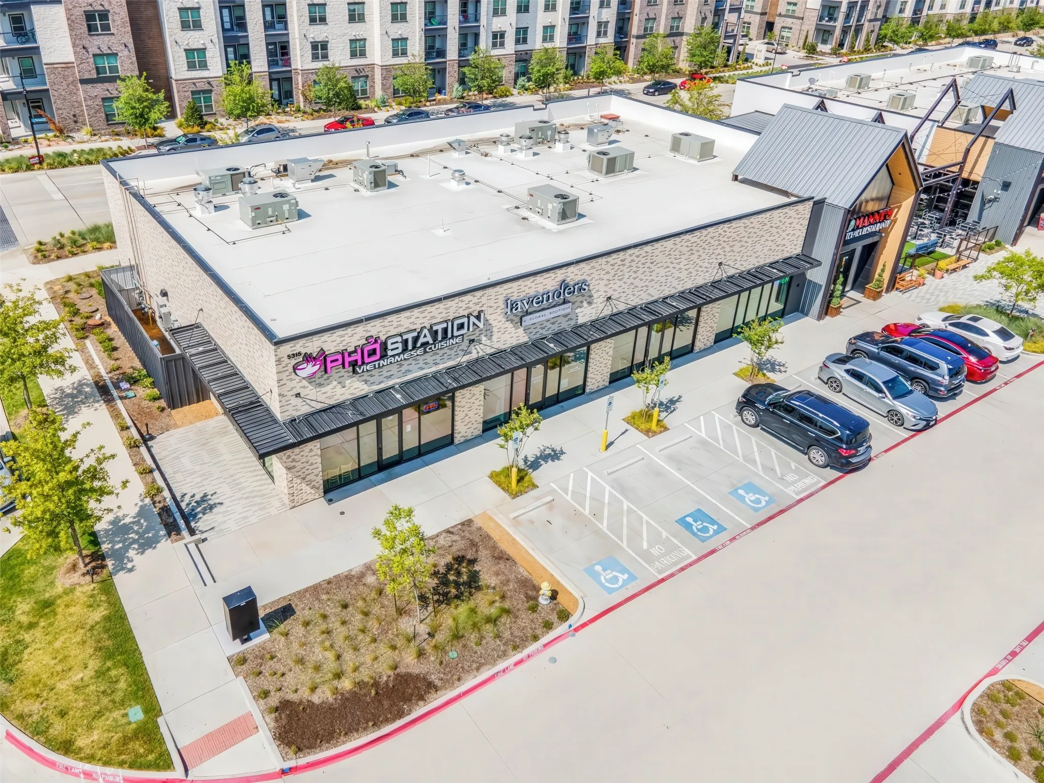 Commercial building with brick facade, multiple storefronts, and a flat roof