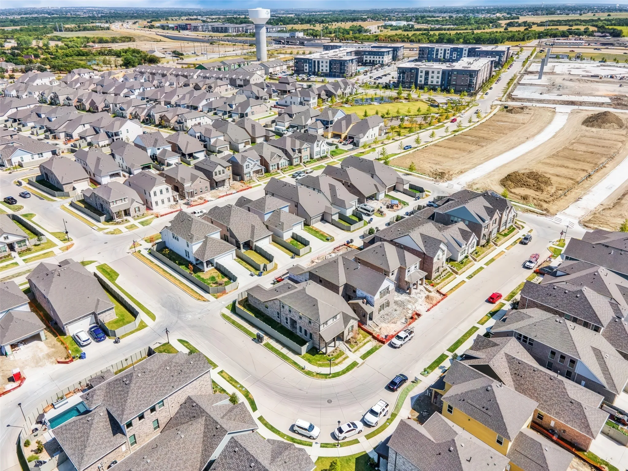 Aerial perspective of a developed residential neighborhood with a variety of single-family homes and multi-story buildings