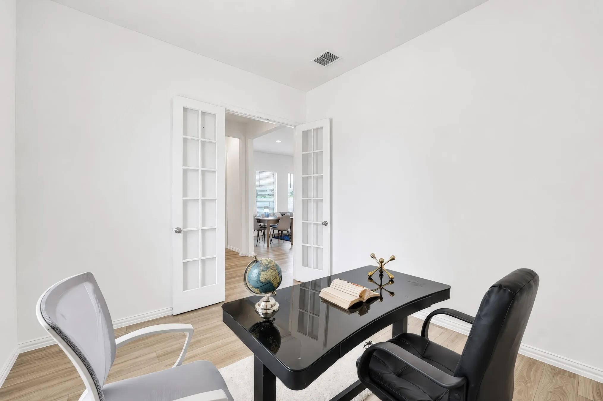 French doors with glass panes, wood-finish flooring, and white painted walls