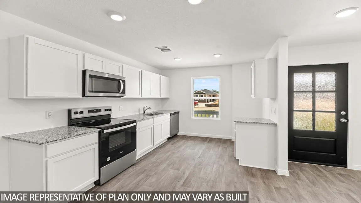 Kitchen featuring white cabinetry, stainless steel appliances, granite countertops, and wood-finish flooring
