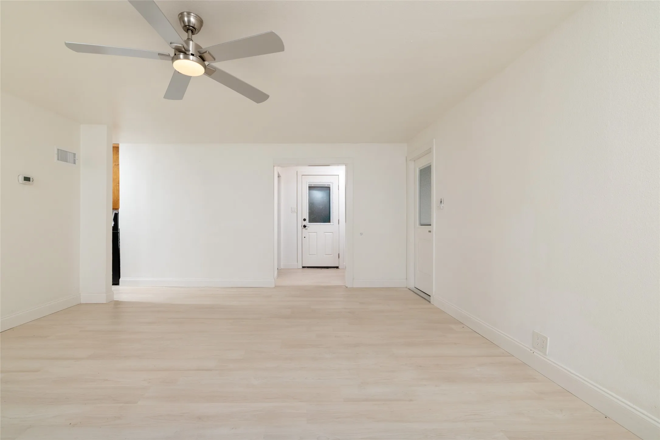 Recessed lighting, wood-finish flooring, ceiling fan with integrated lighting, white interior doors