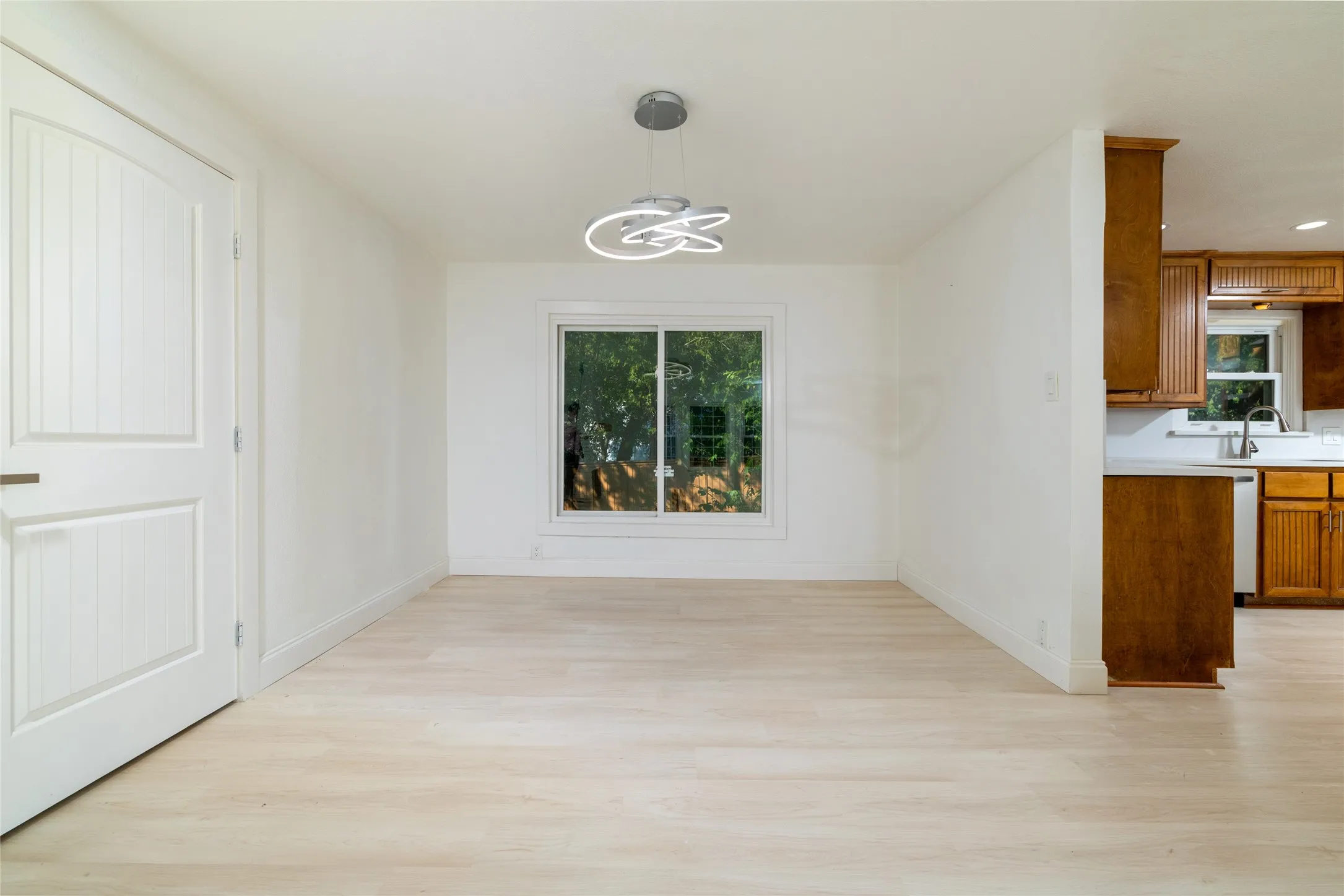 Light-toned wood-finish flooring throughout