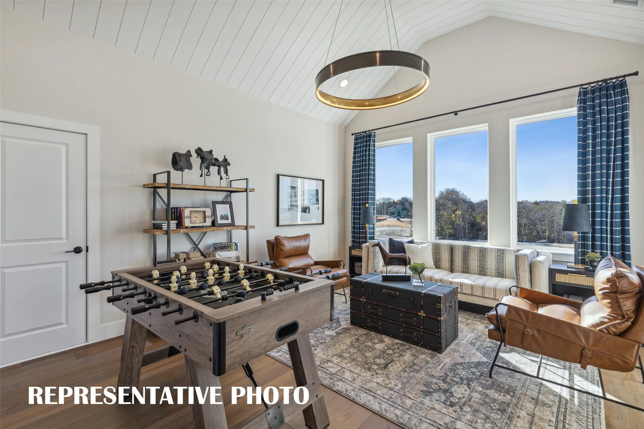 The entire family will enjoy hours of fun time in this light filled game room!  REPRESENTATIVE PHOTO