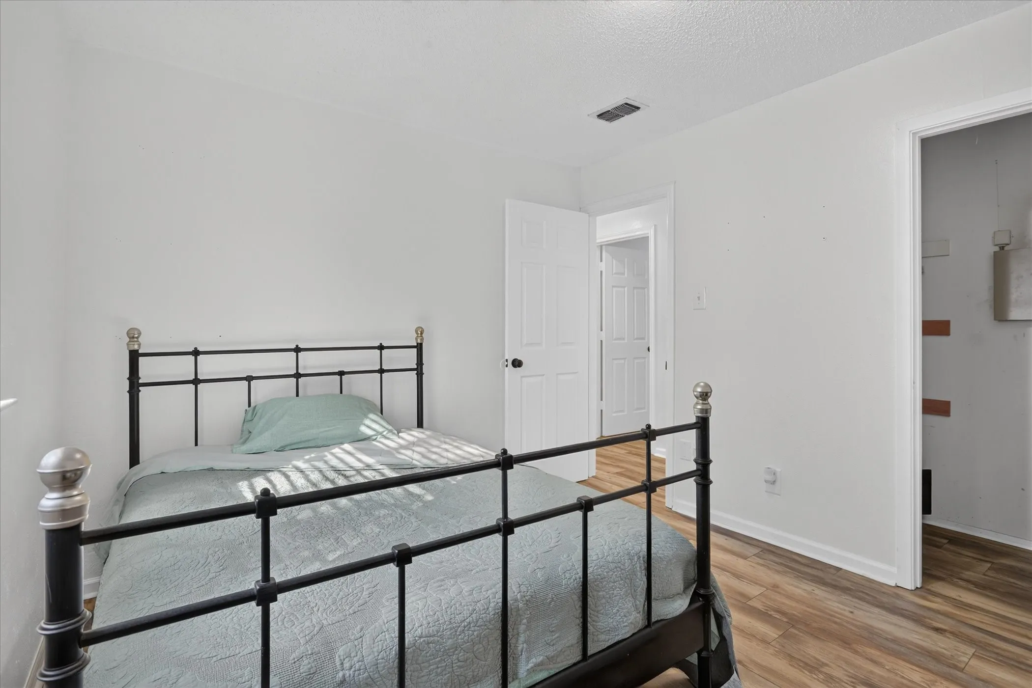 Wood-finish flooring, white walls, and white trim