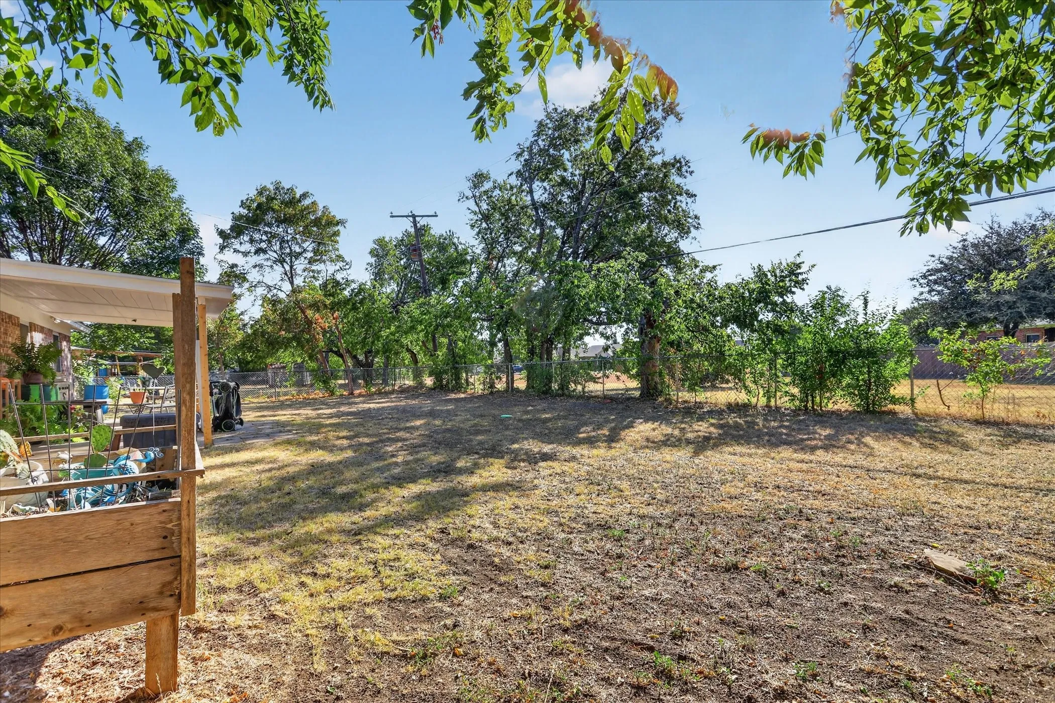 Expansive lot with mature trees and a fenced perimeter