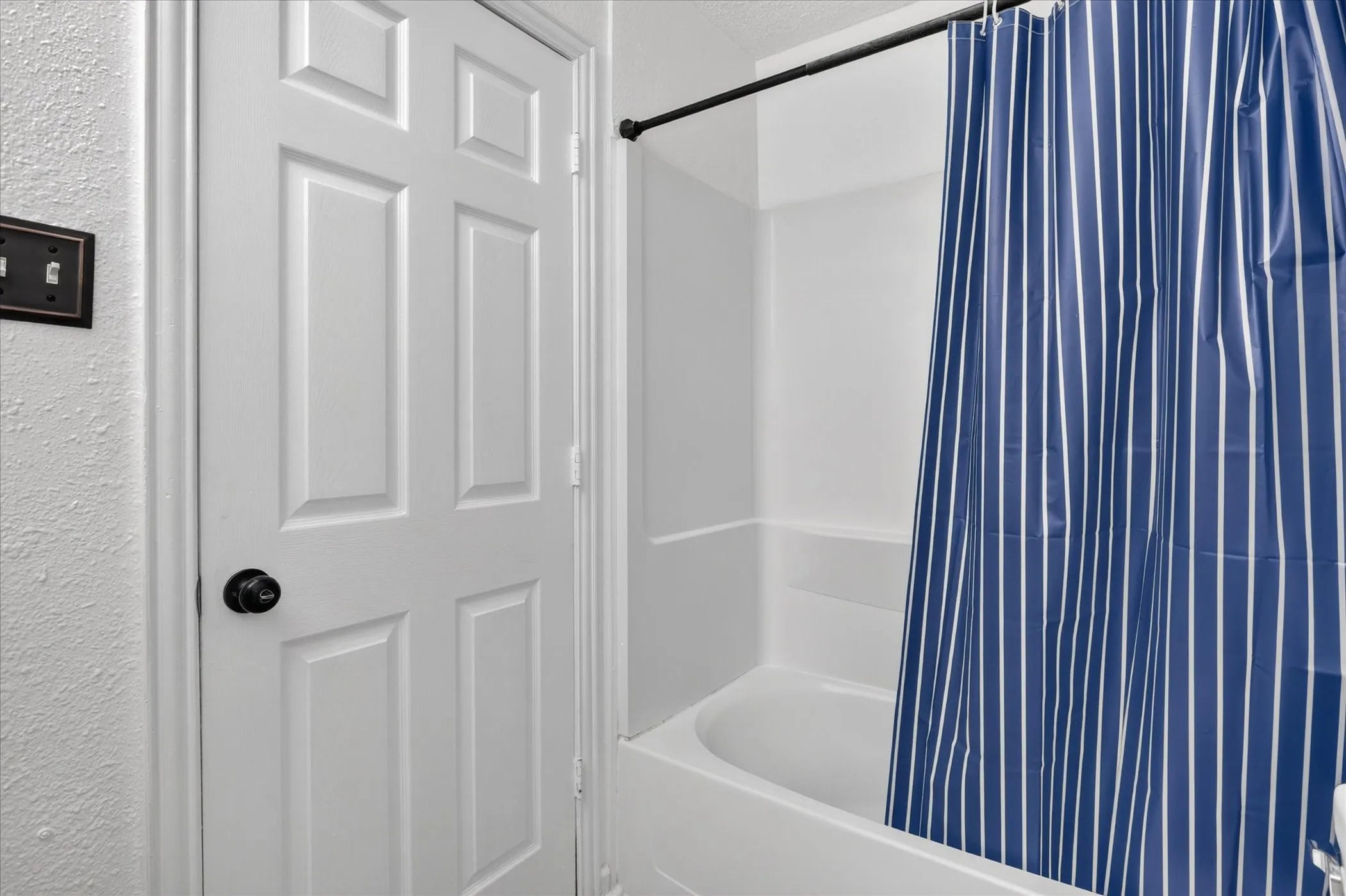 White paneled door with a black knob