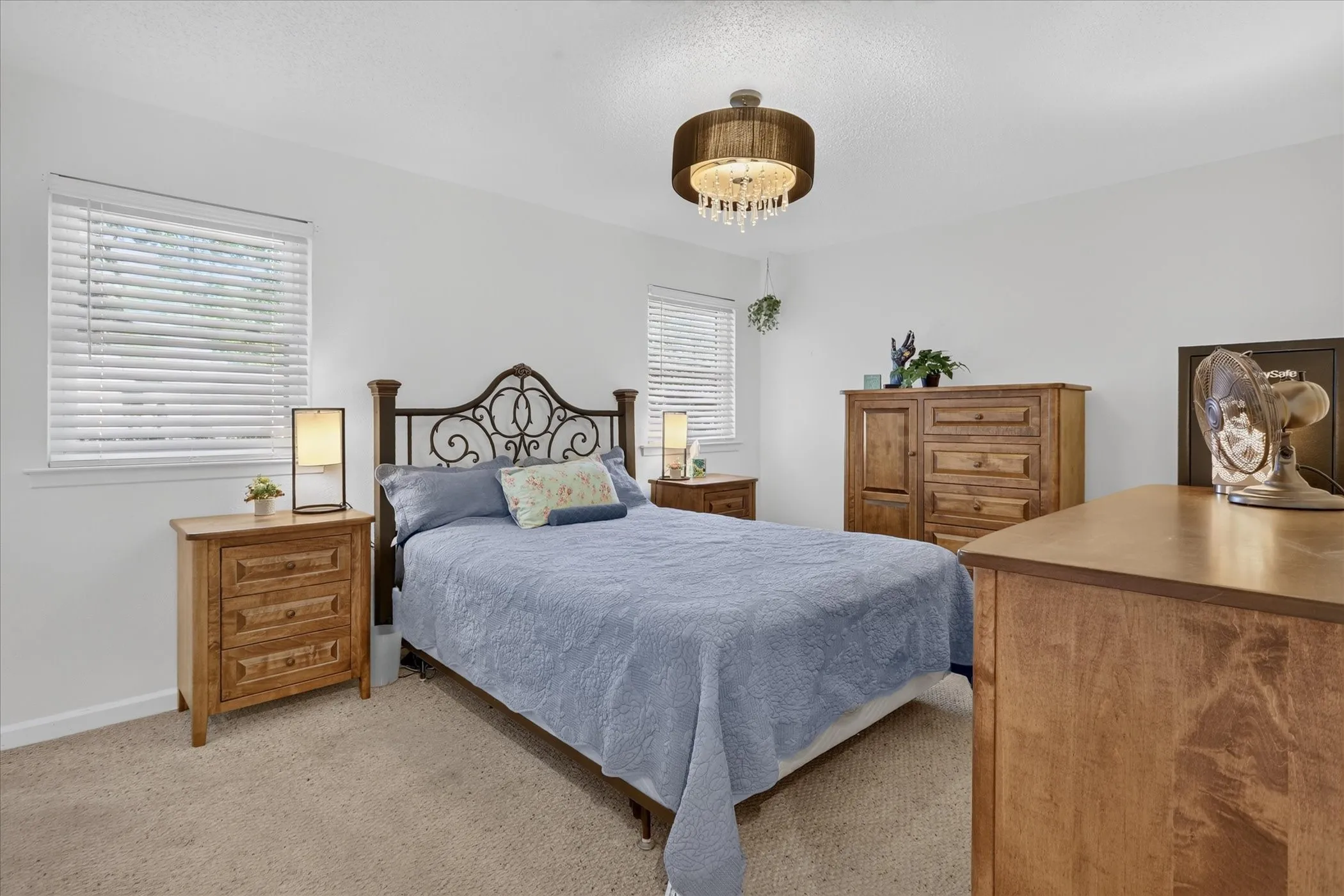 Recessed lighting, crown molding, and a chandelier with crystal accents