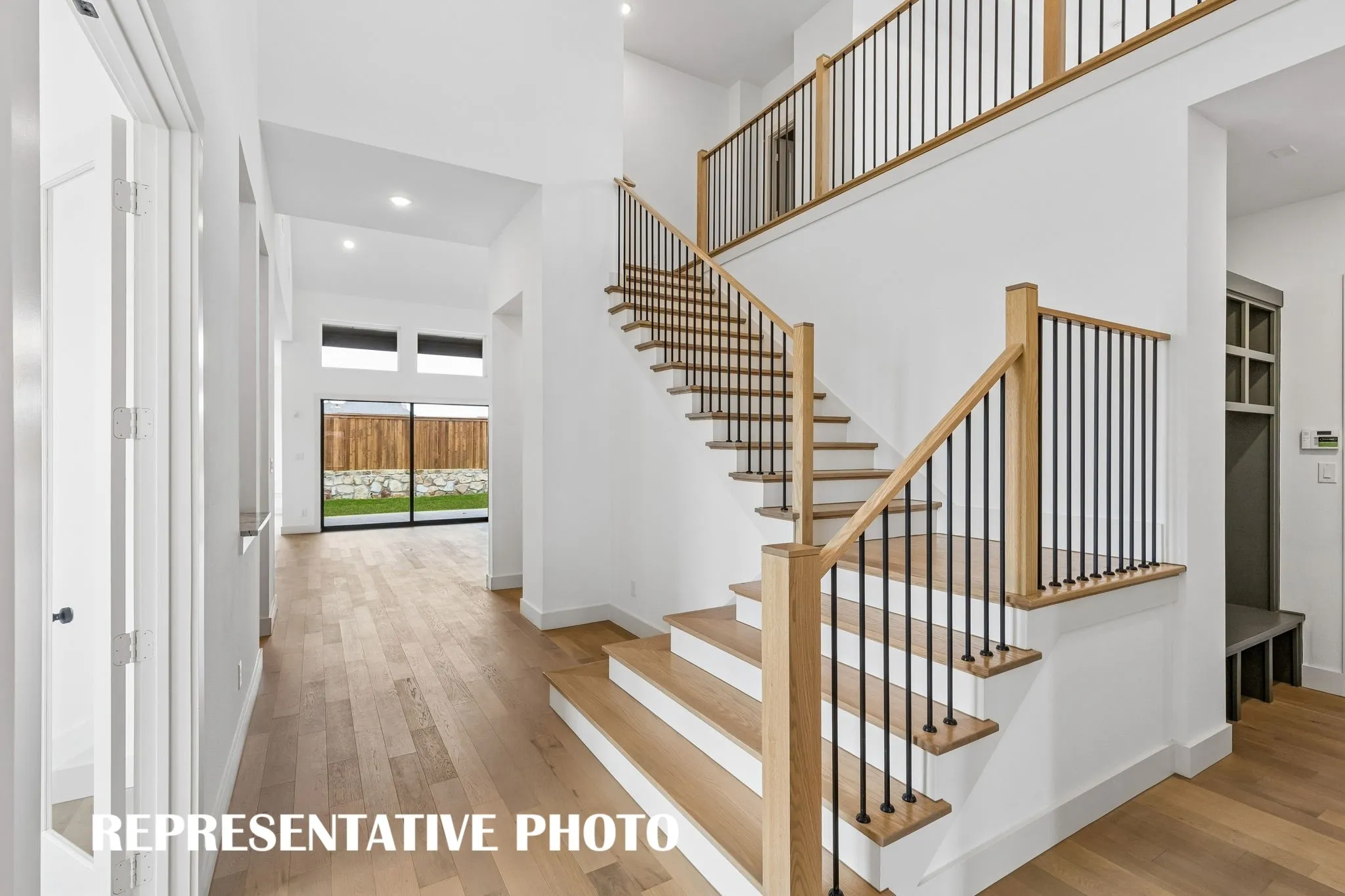 Offering a dramatic entrance with luxury finishes and sight lines from the front door to the back of the home, you will love welcoming family and friends into this over the top dream home!  REPRESENTATIVE PHOTO