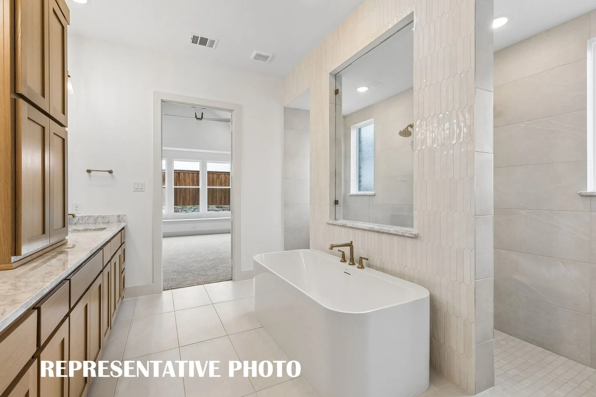 Featuring our signature bath with free standing tub and double walk through shower, you'll enjoy a spa like experience every day in this dream home!  REPRESENTATIVE PHOTO