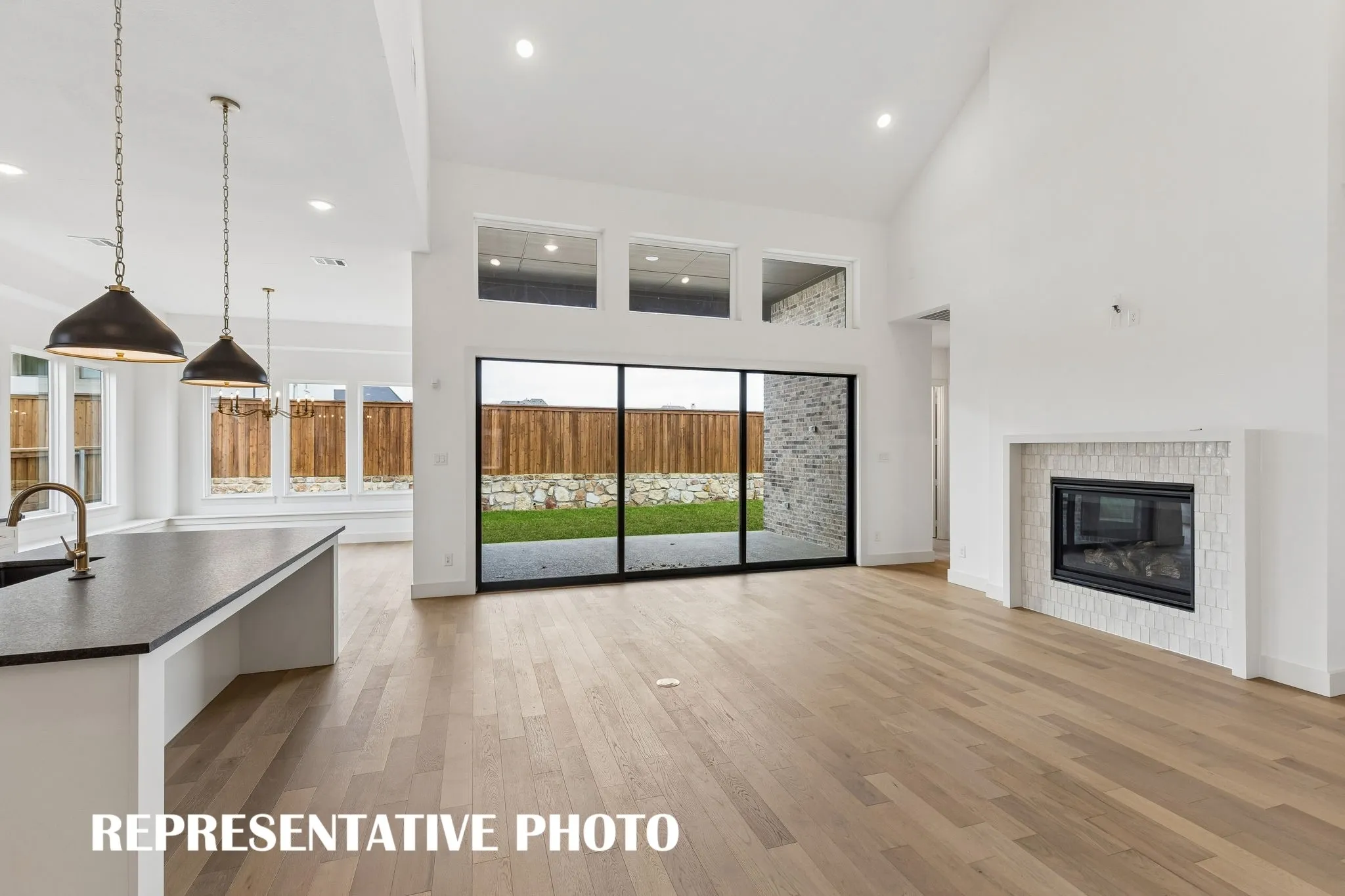 Entertaining family and friends is a breeze in this spacious family room that opens to the covered back patio and effortlessly flows into the kitchen and dining areas.  REPRESENTATIVE PHOTO
