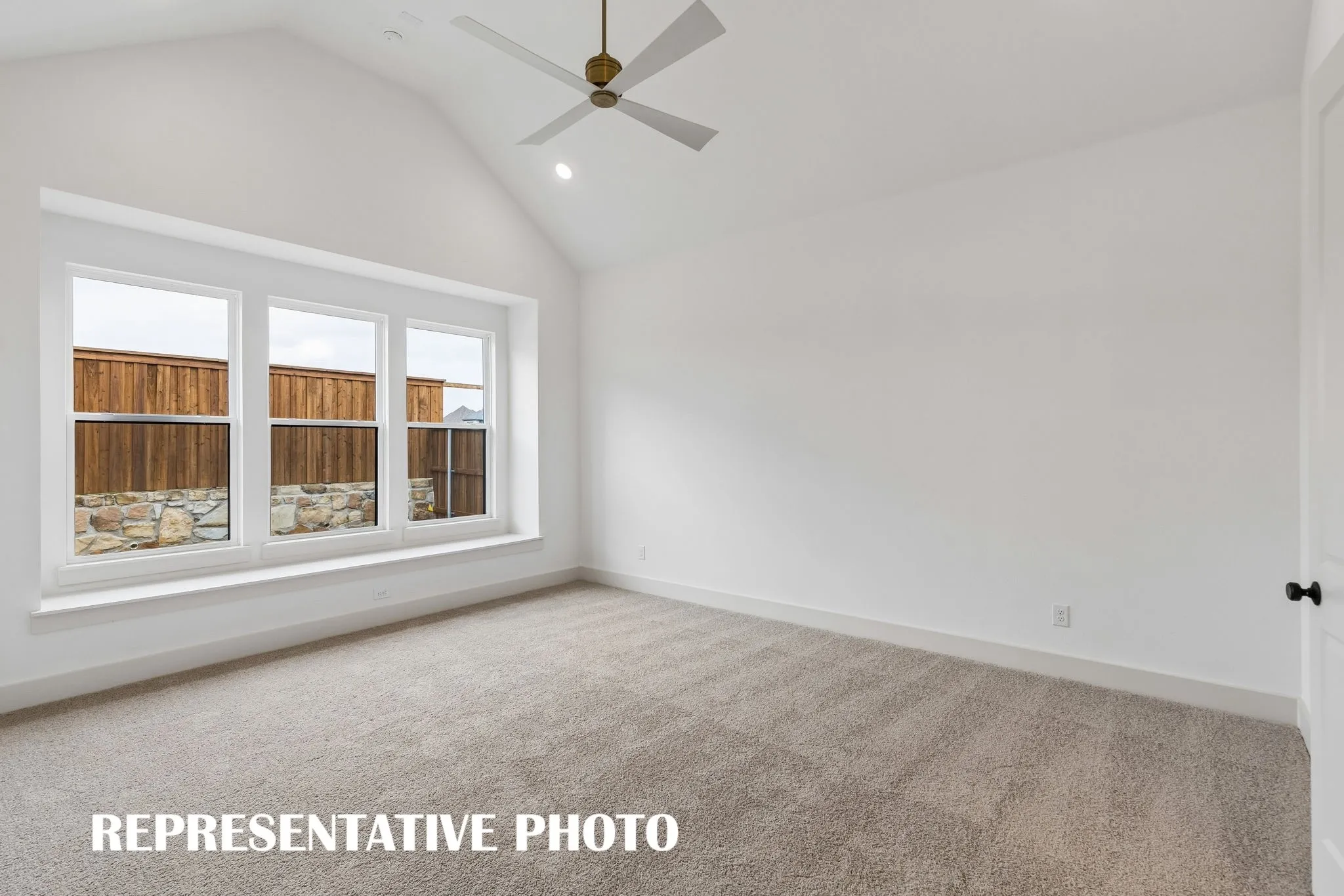 Featuring high ceilings, a built in window seat and neutral color palette, this owner's suite was designed for rest and relaxation.  REPRESENTATIVE PHOTO