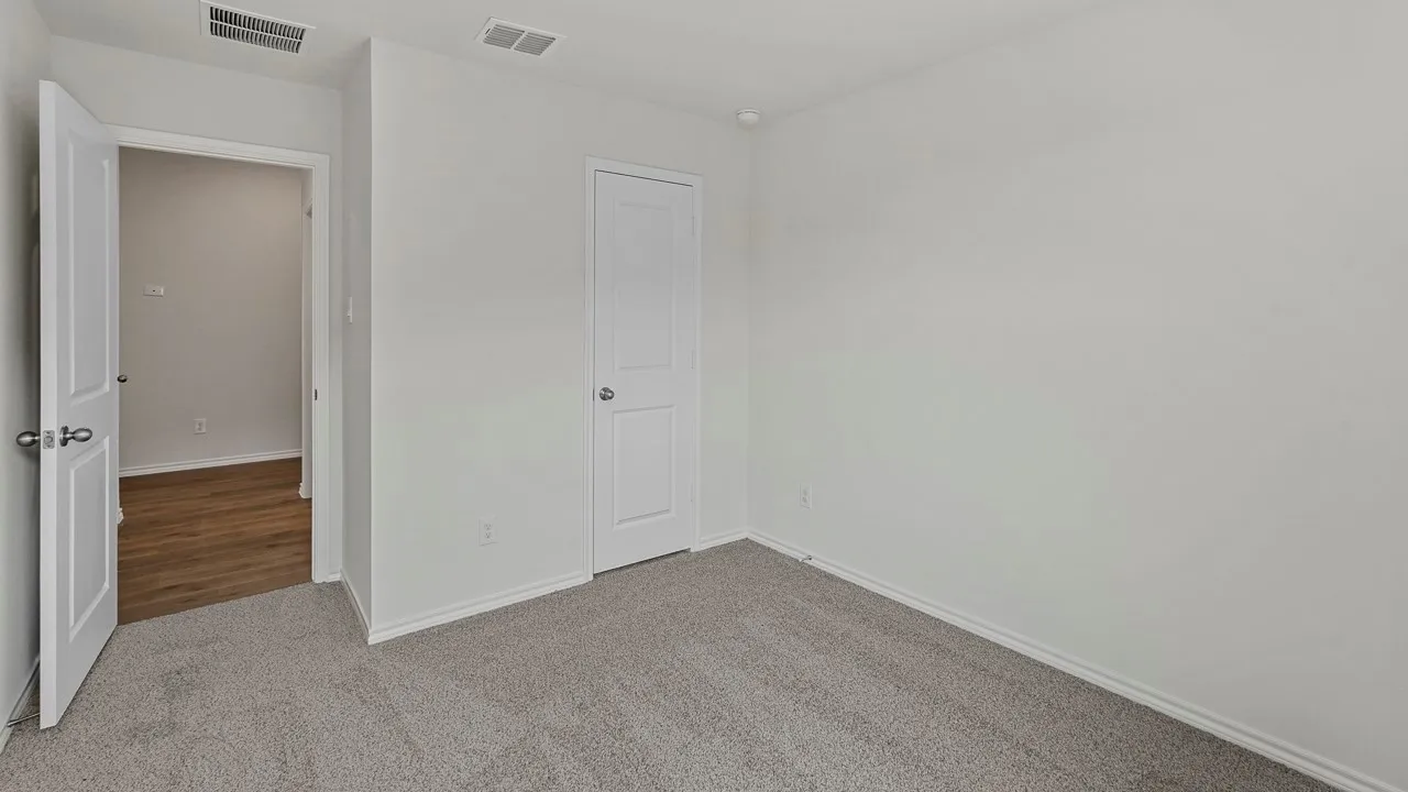 Neutral wall color, carpeted flooring, white trim, and white paneled doors