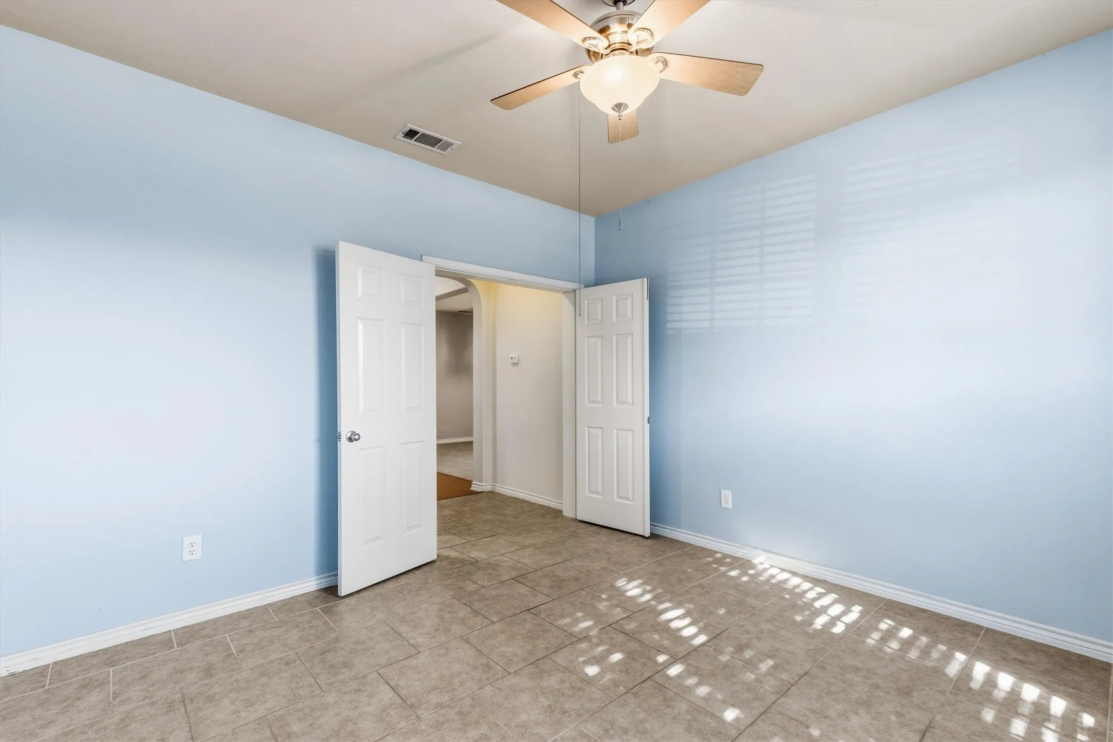 First floor with a window and ceiling fan.
