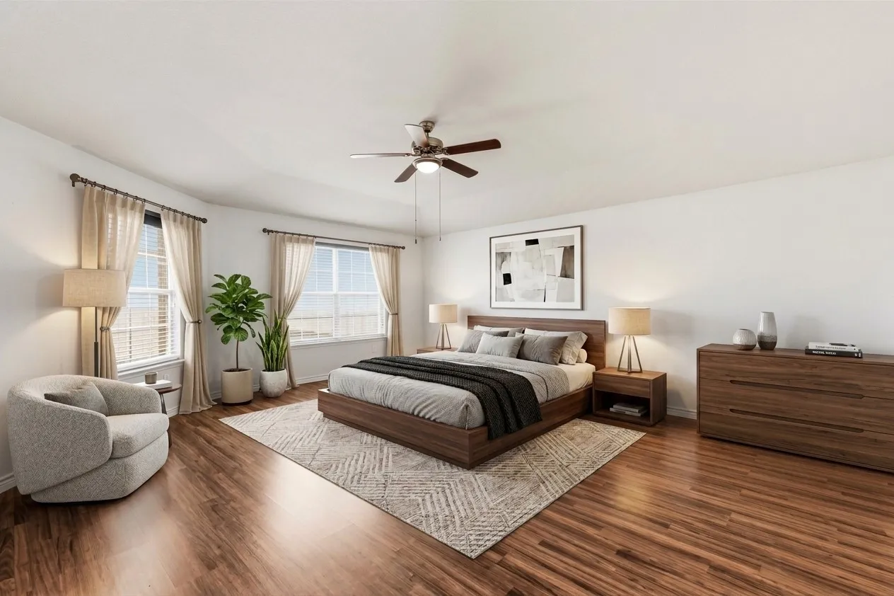 Second floor primary bedroom with a primary bathroom and two walk in closet separated and natural lighting with a ceiling fan. The furniture and decor is virtual staged from the original photo.