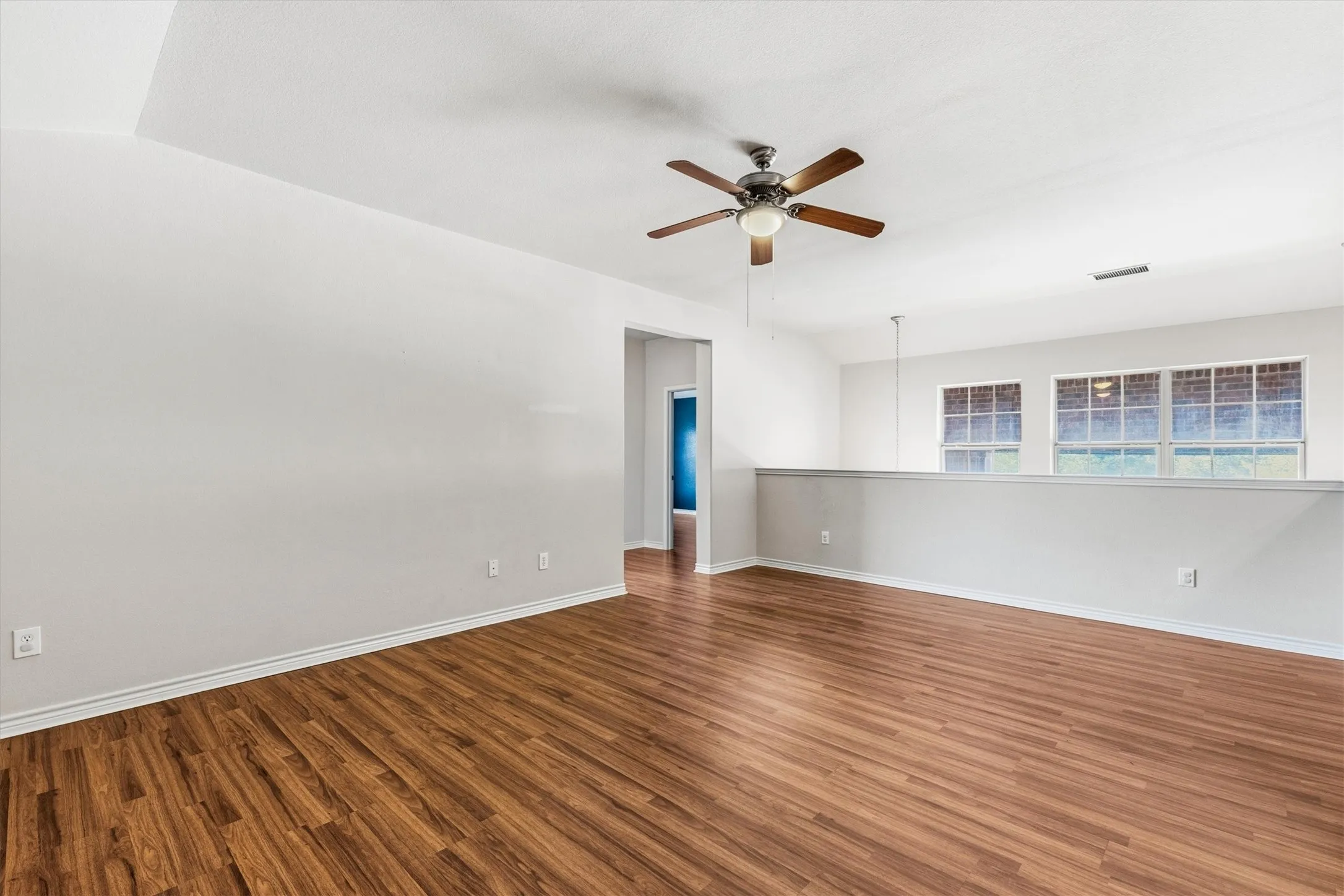 Open Game room, second floor with ceiling fan.