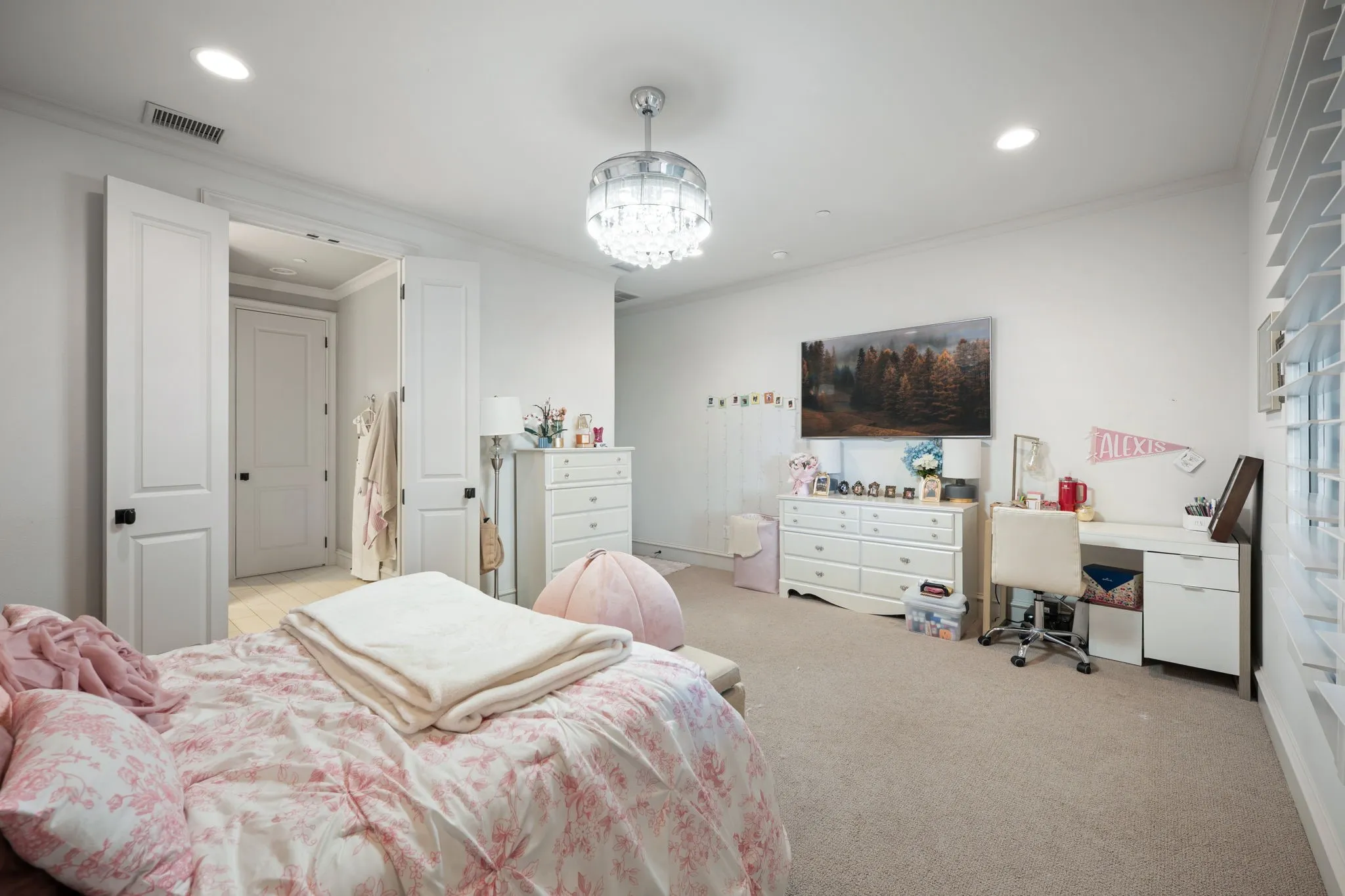Recessed lighting, crown molding, double paneled doors, carpet flooring, and a crystal chandelier
