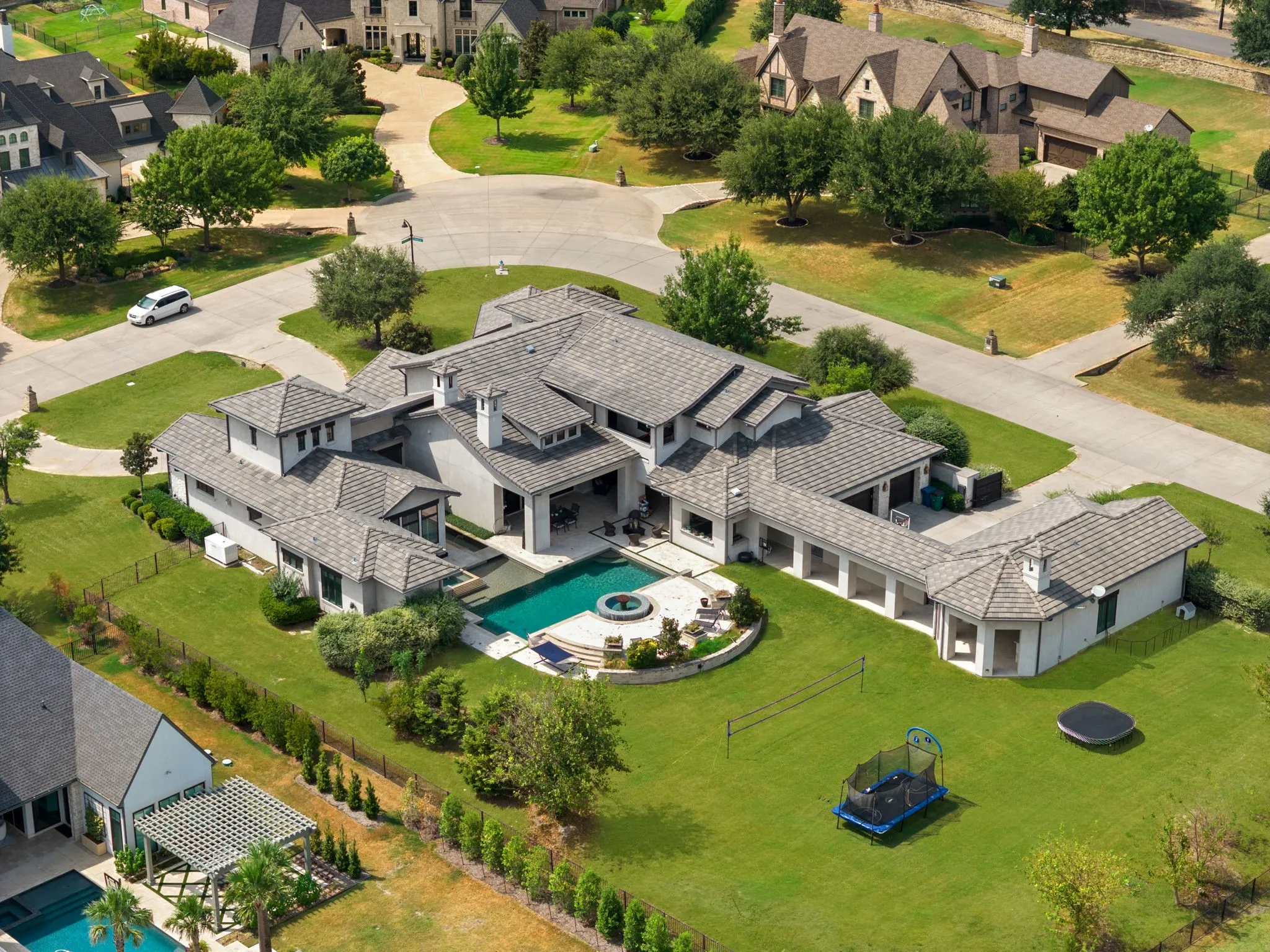 Extensive property featuring a multi-level structure, a large swimming pool with an integrated spa, and a spacious lawn