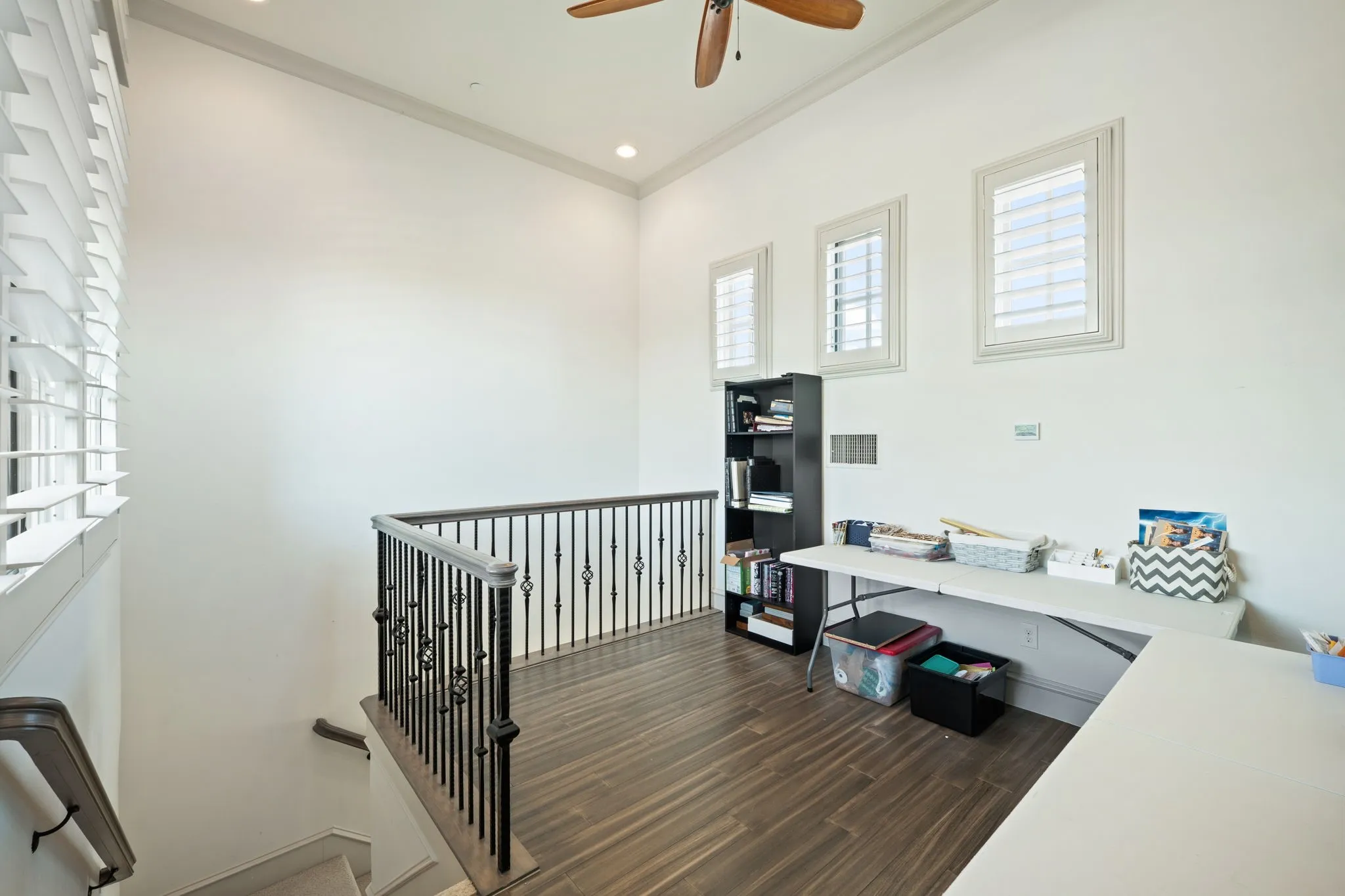 Loft space featuring wood-finish flooring, recessed lighting, and a ceiling fan