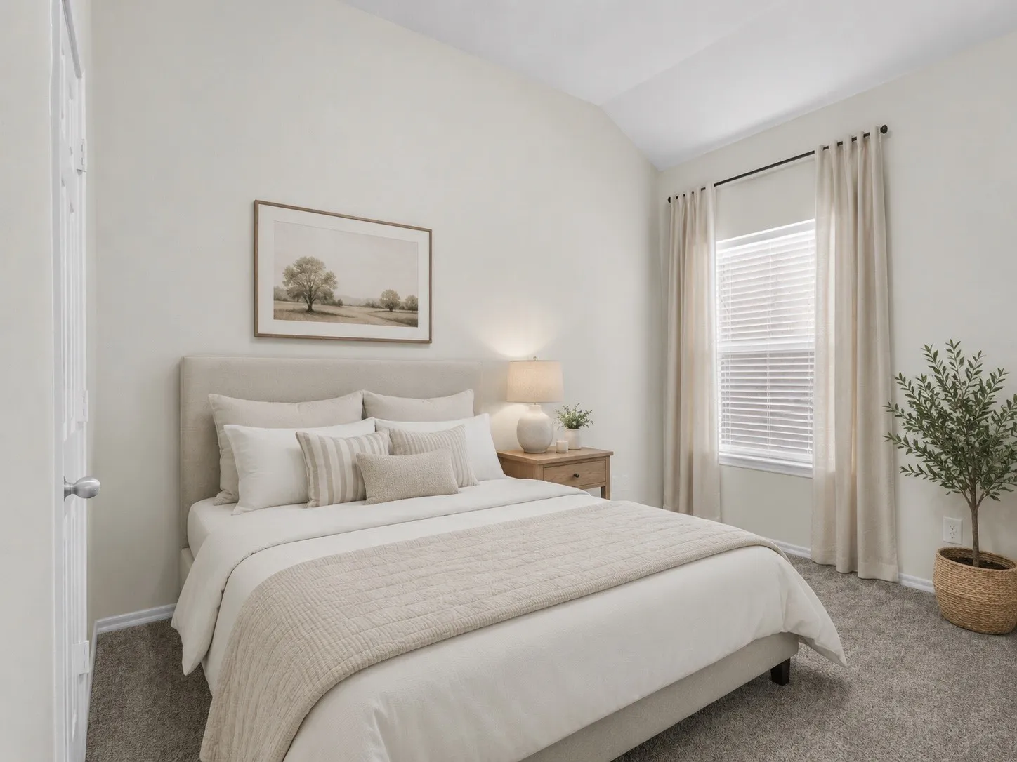 Vaulted ceiling, window with blinds, carpeted flooring, and a paneled door