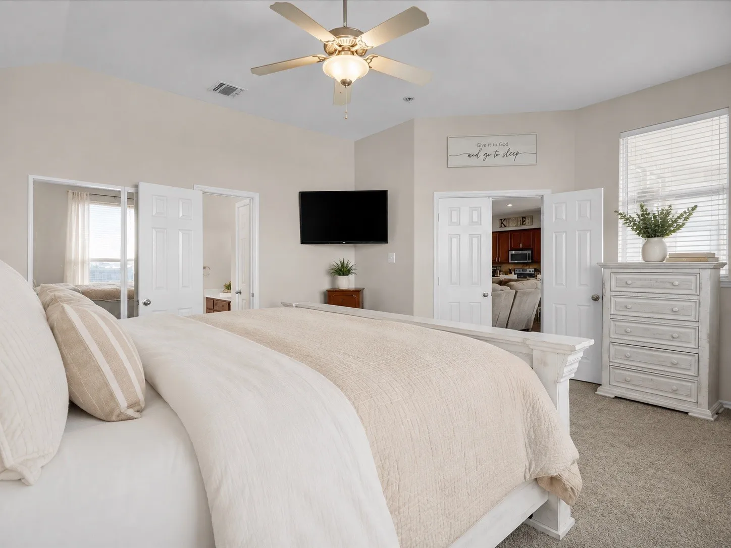 Vaulted ceiling with a ceiling fan, carpet flooring, window with blinds, and white paneled doors