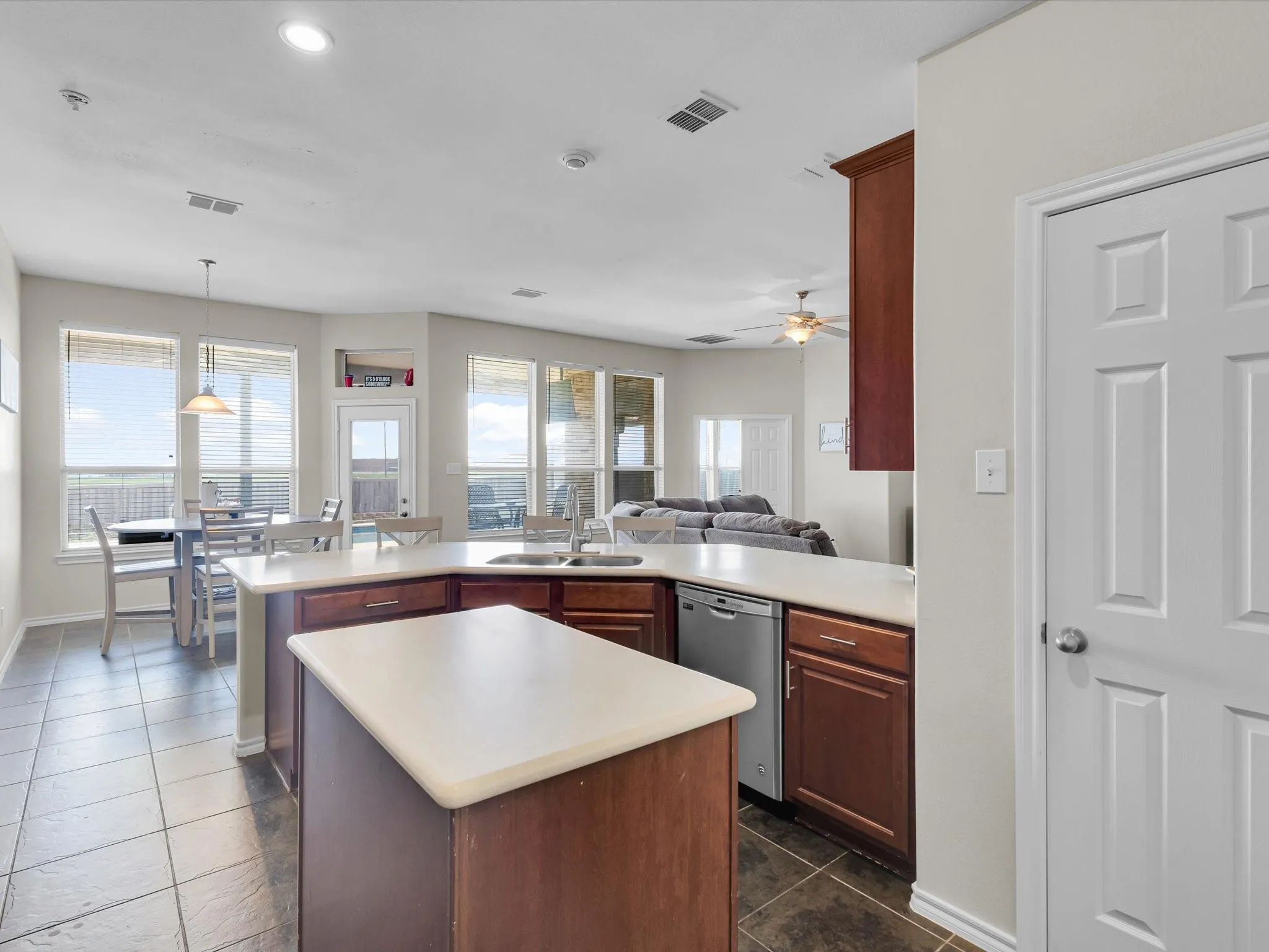 Kitchen featuring a center island, wood-finish cabinetry, and recessed lighting