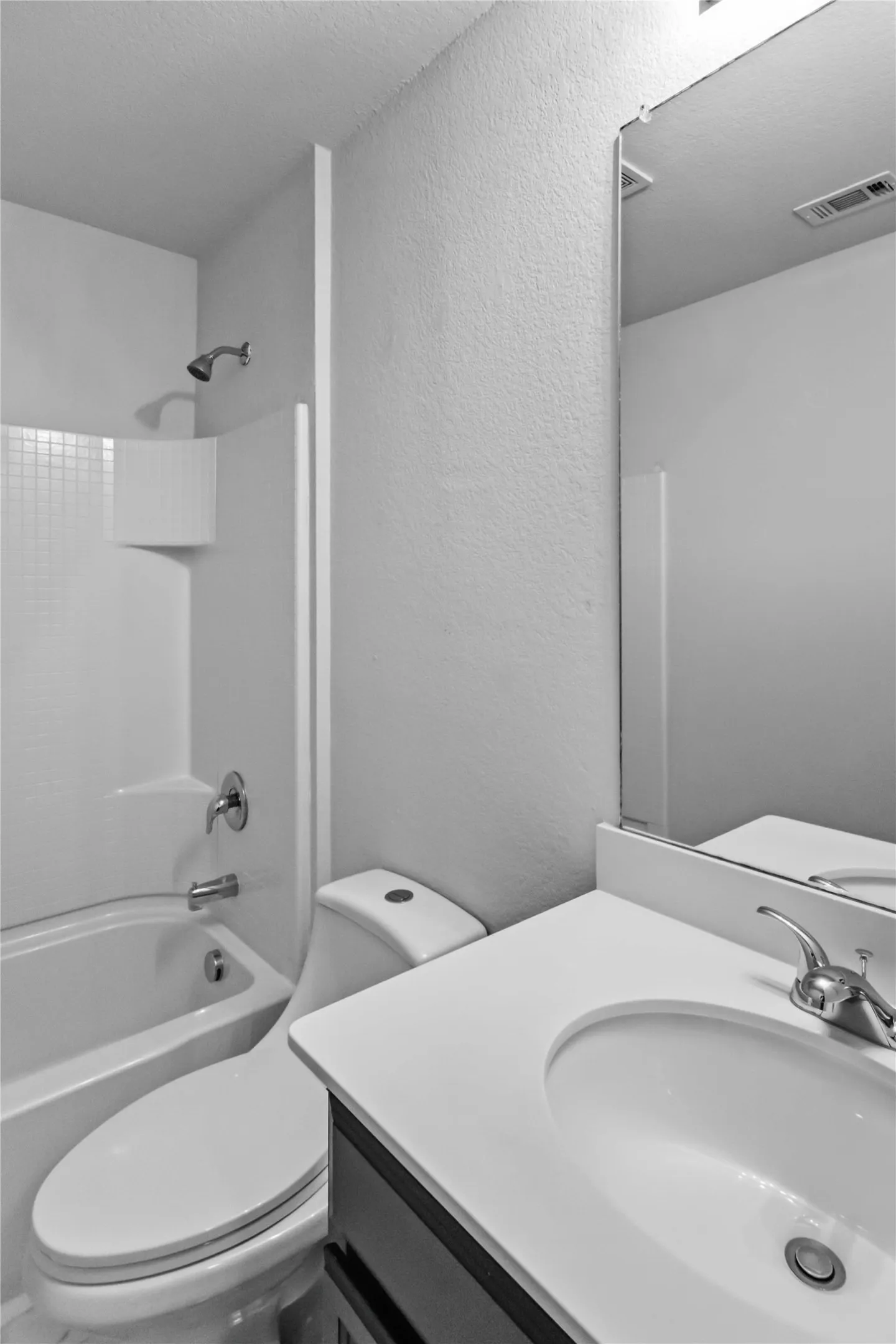 Vanity with integrated sink, polished chrome faucet, and full-width mirror