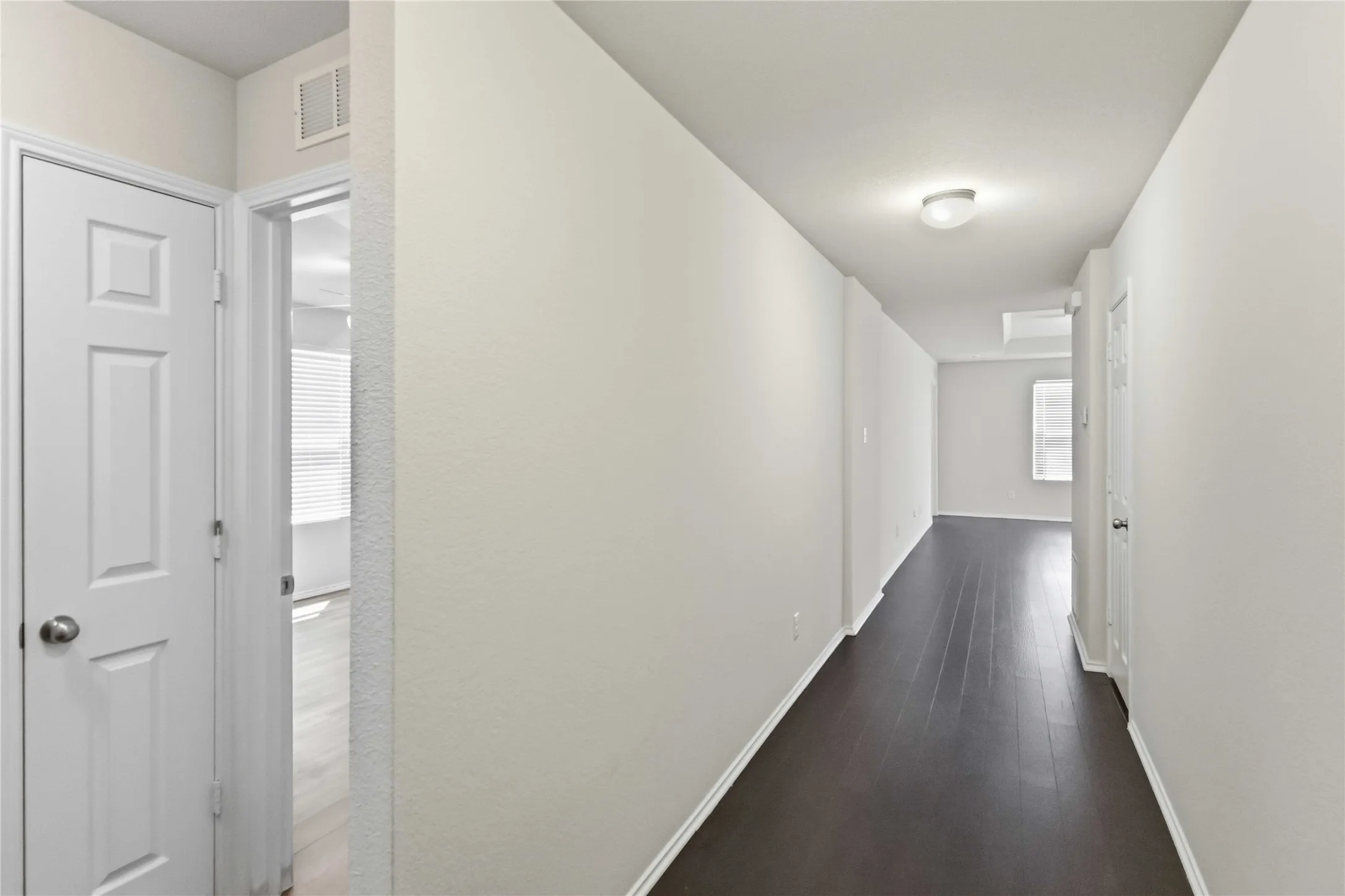 Wood-finish flooring throughout, complemented by light-toned walls and crisp white trim