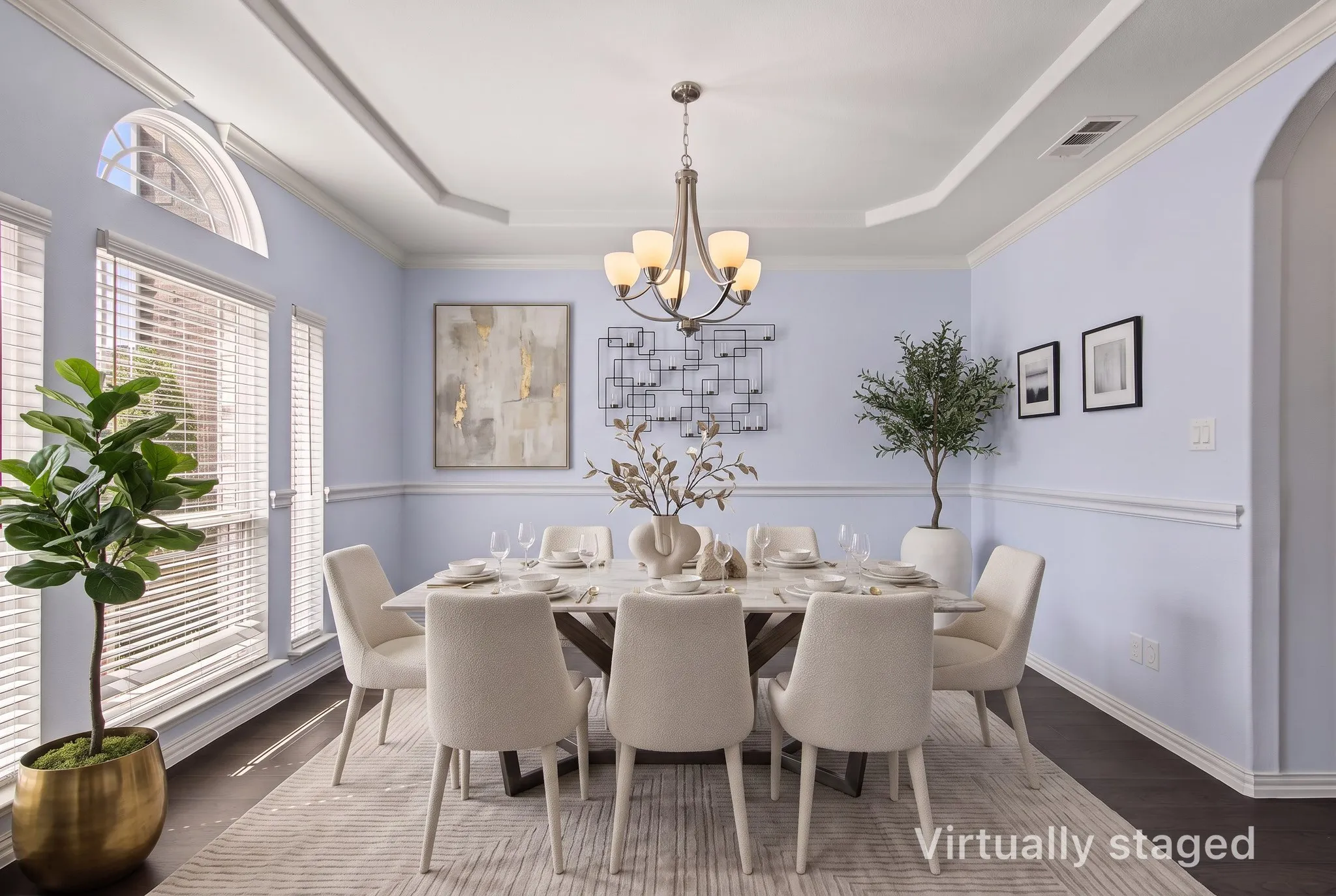 Tray ceiling with recessed lighting and a central chandelier