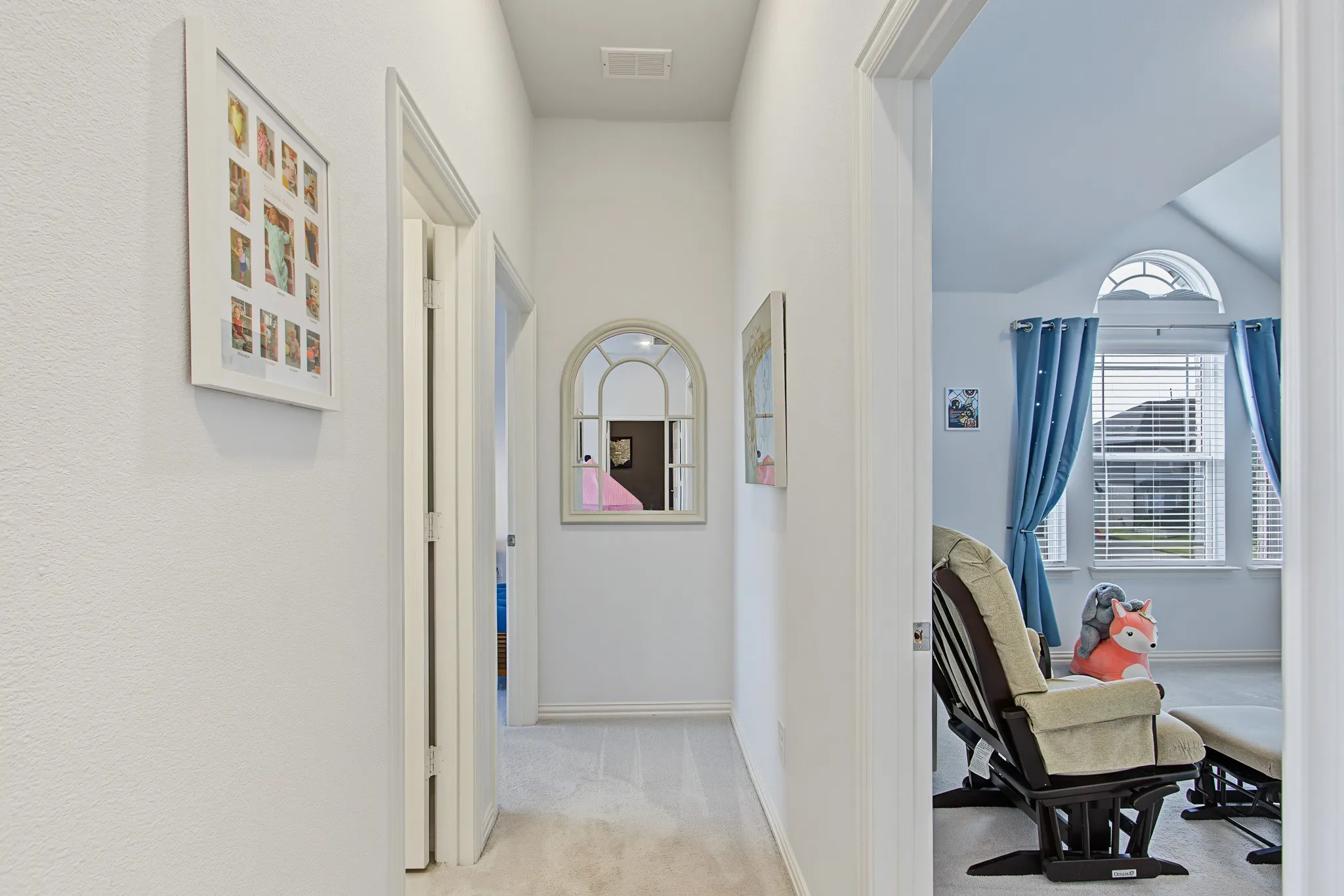 Carpeted hallway with painted walls and white trim