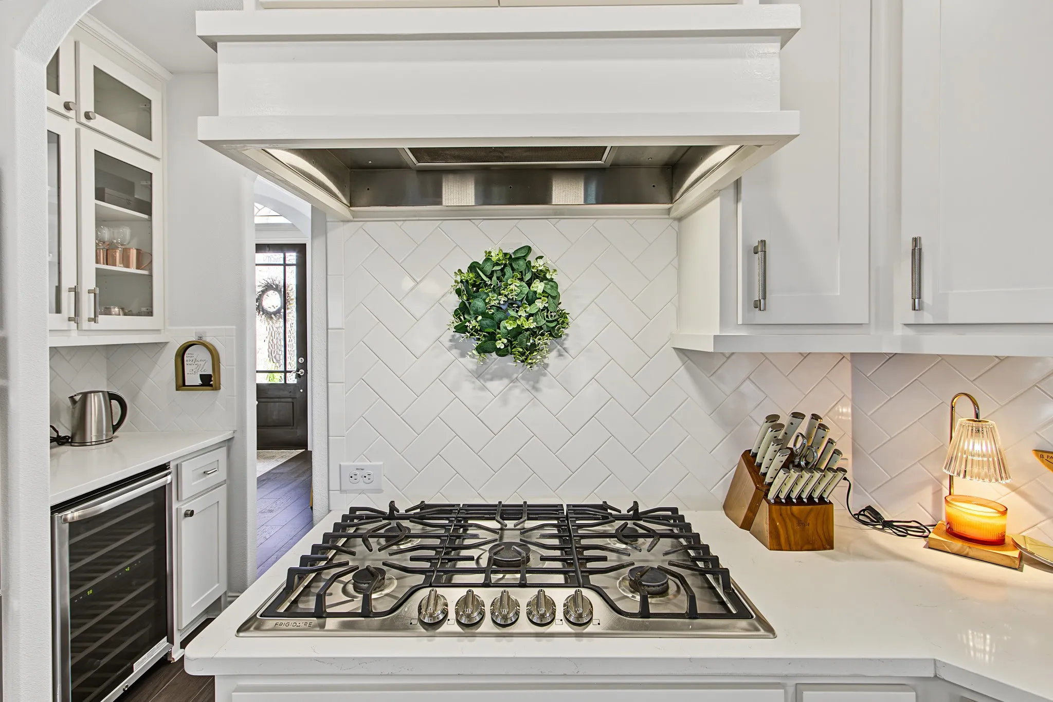 Stainless steel gas cooktop with a coordinating range hood