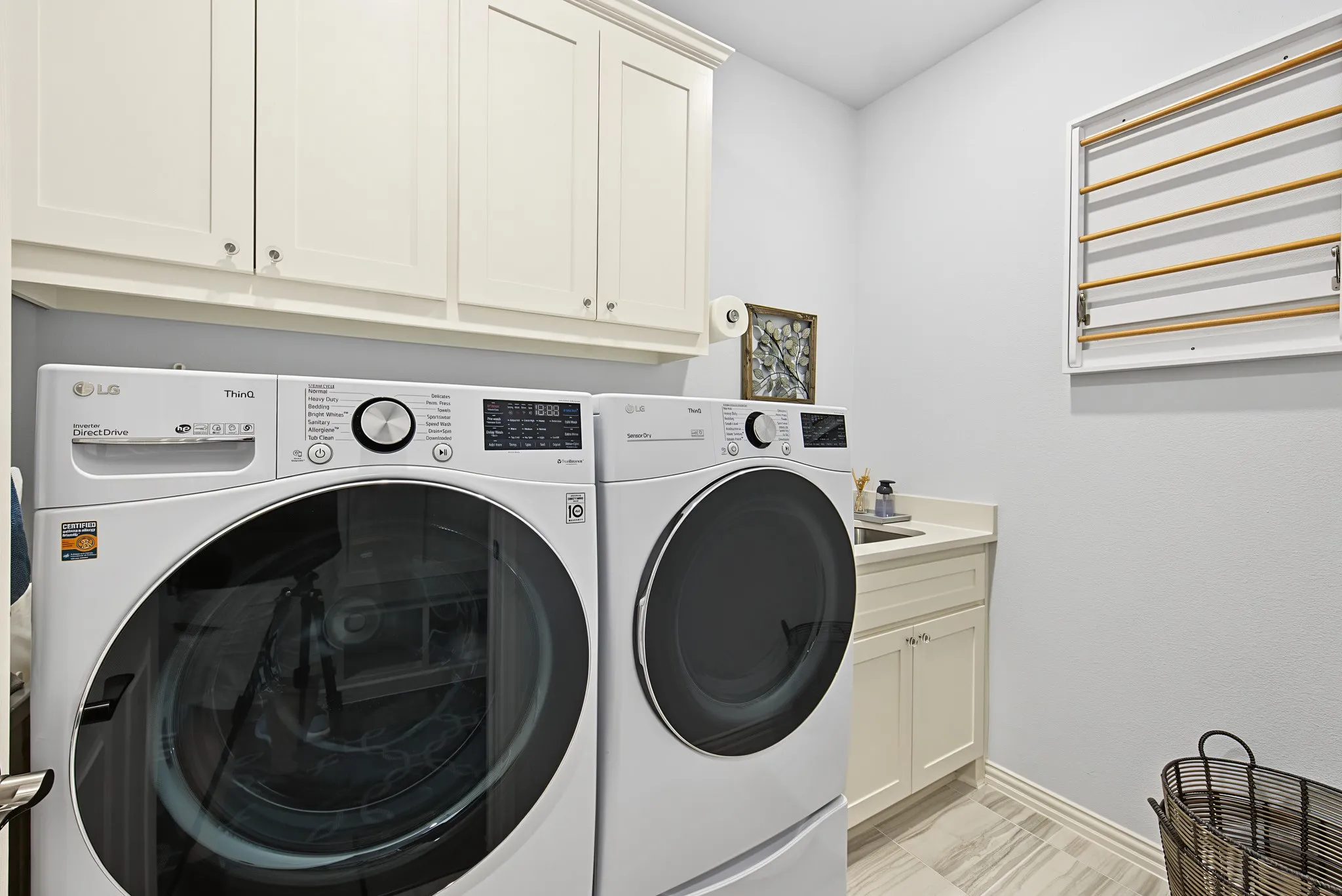 Built-in cabinetry, an under-mount sink, light-toned countertops, and wood-finish flooring