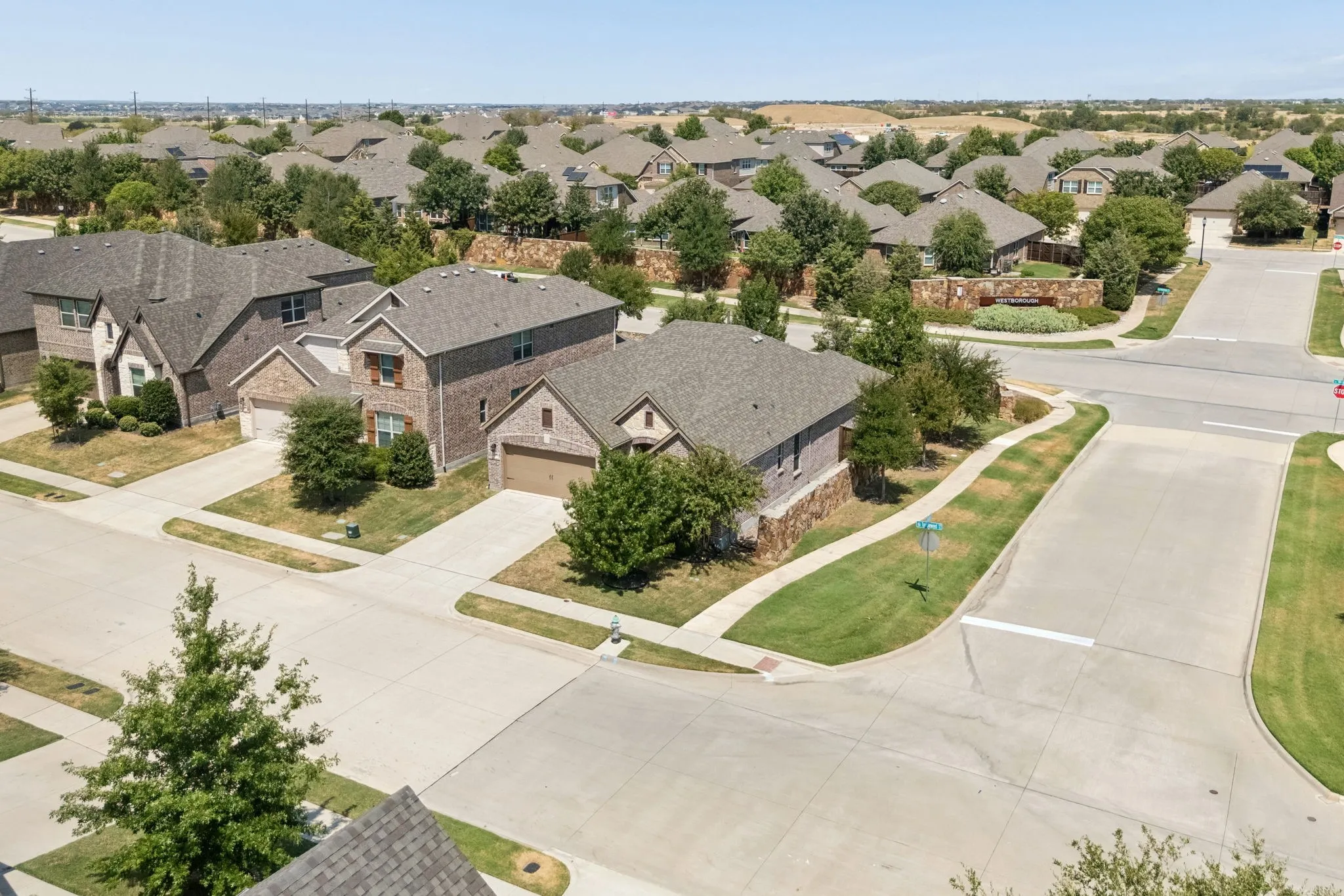 Brick and stone exterior residence with an attached garage, situated on a corner lot
