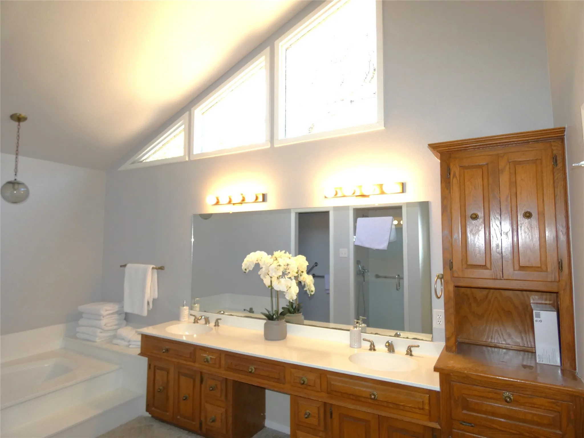 Primary bath with dual vanities, tub and shower.
