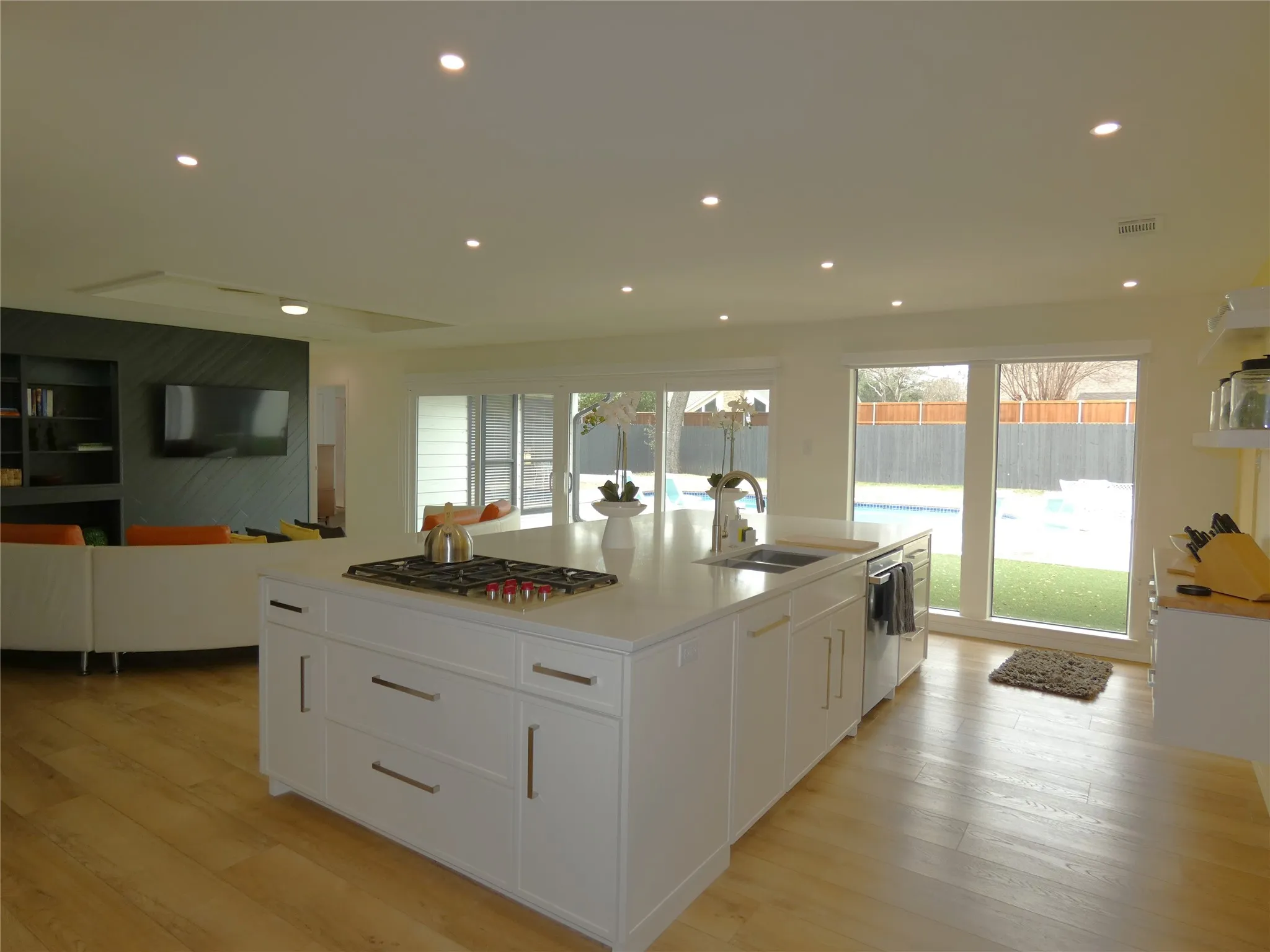 The updated kitchen is open to the second living area and has views of pool area.