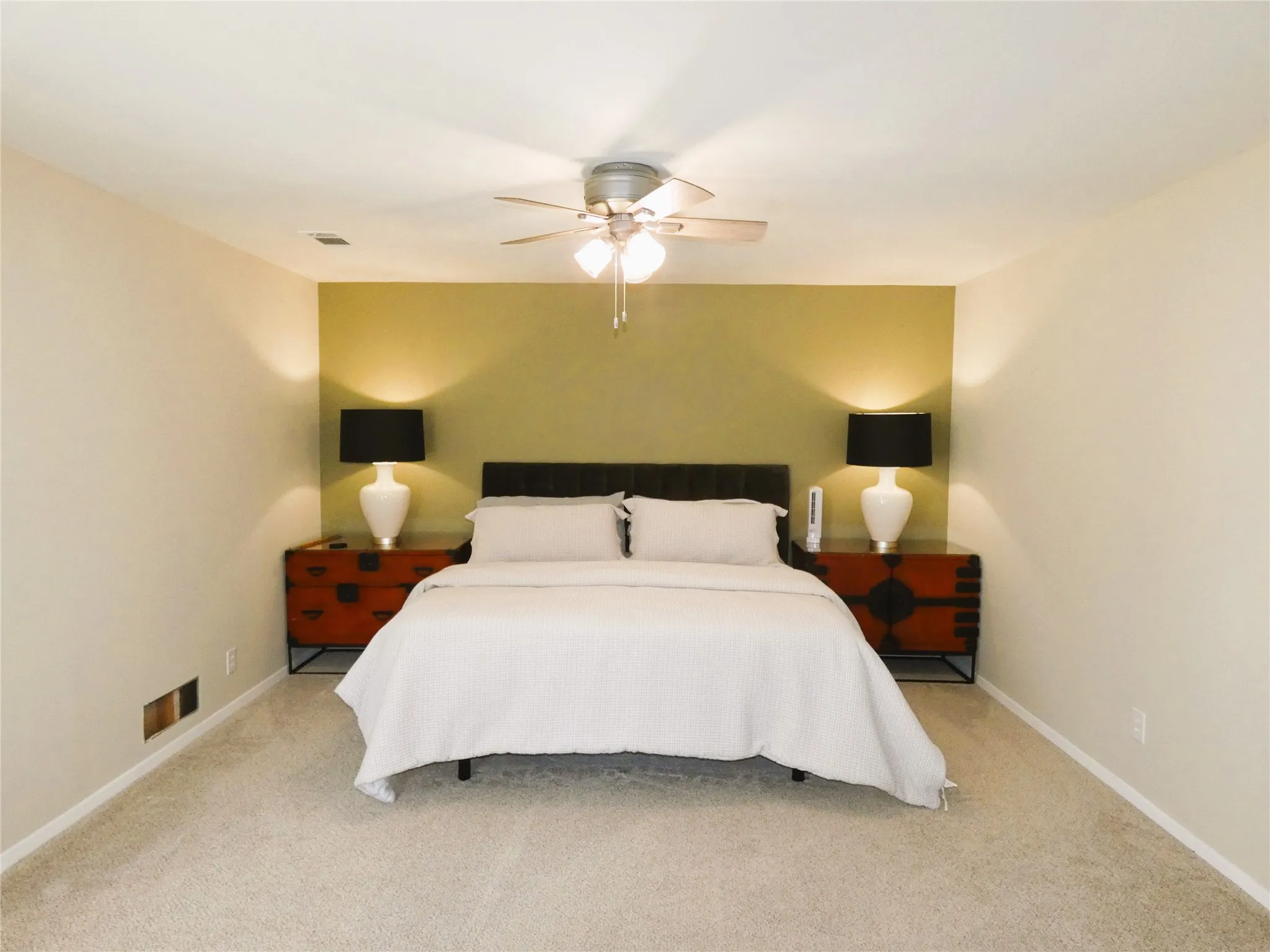 Primary bedroom includes with king bed and additional seating area.