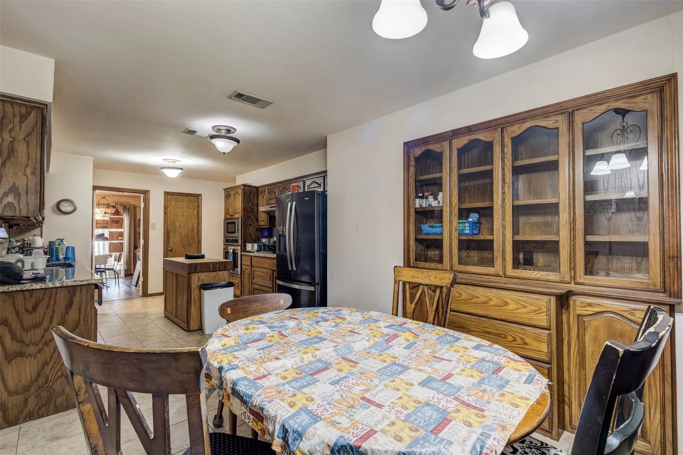 Built-in cabinetry with glass-front uppers and wood-finish lowers