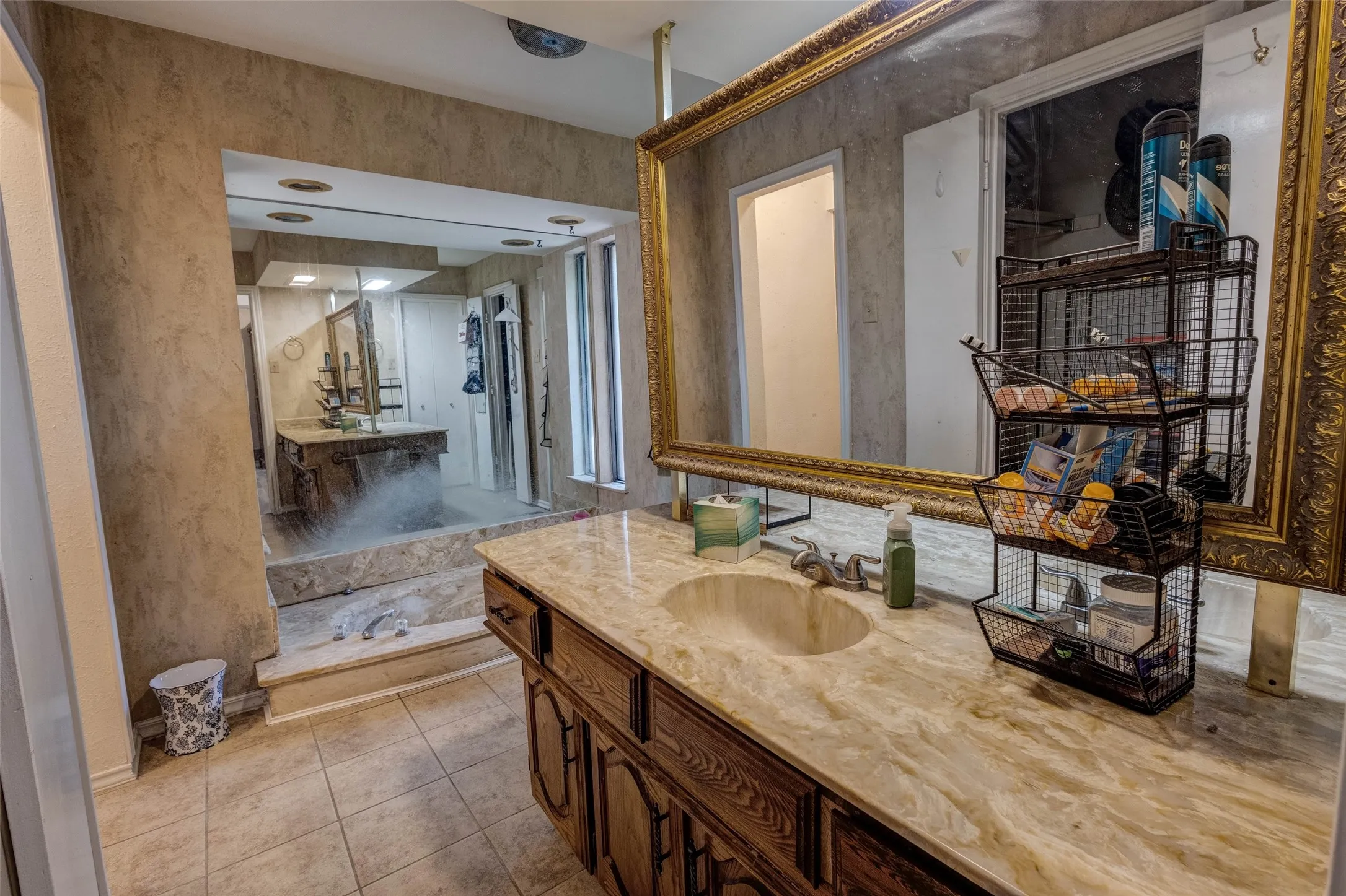 Dual vanity areas featuring stone countertops