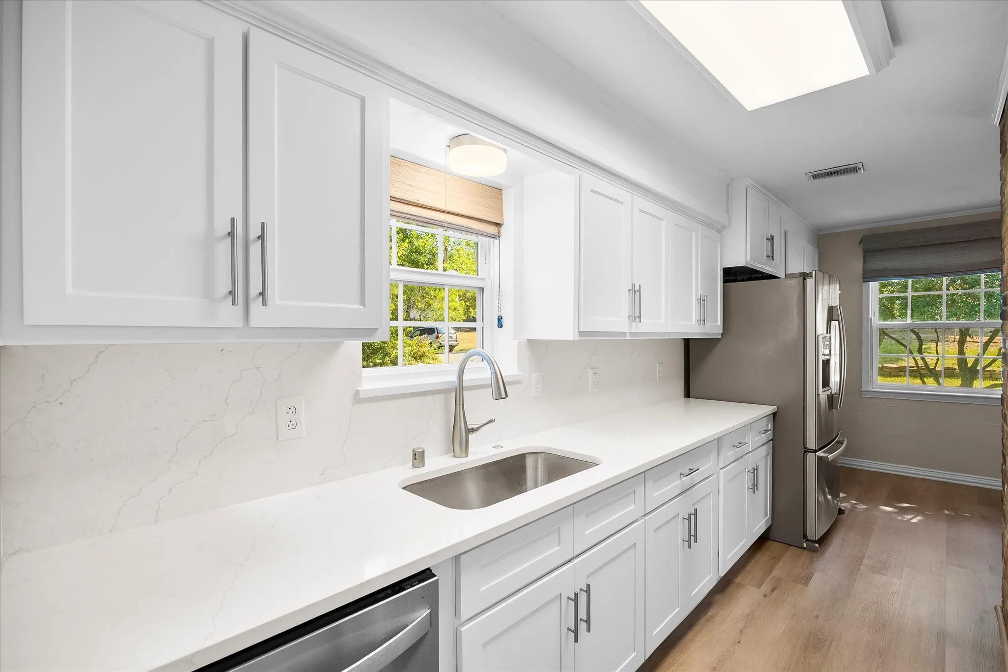 Updated cabinets, hardware and stainless steel appliances will put a smile on your chef's face!