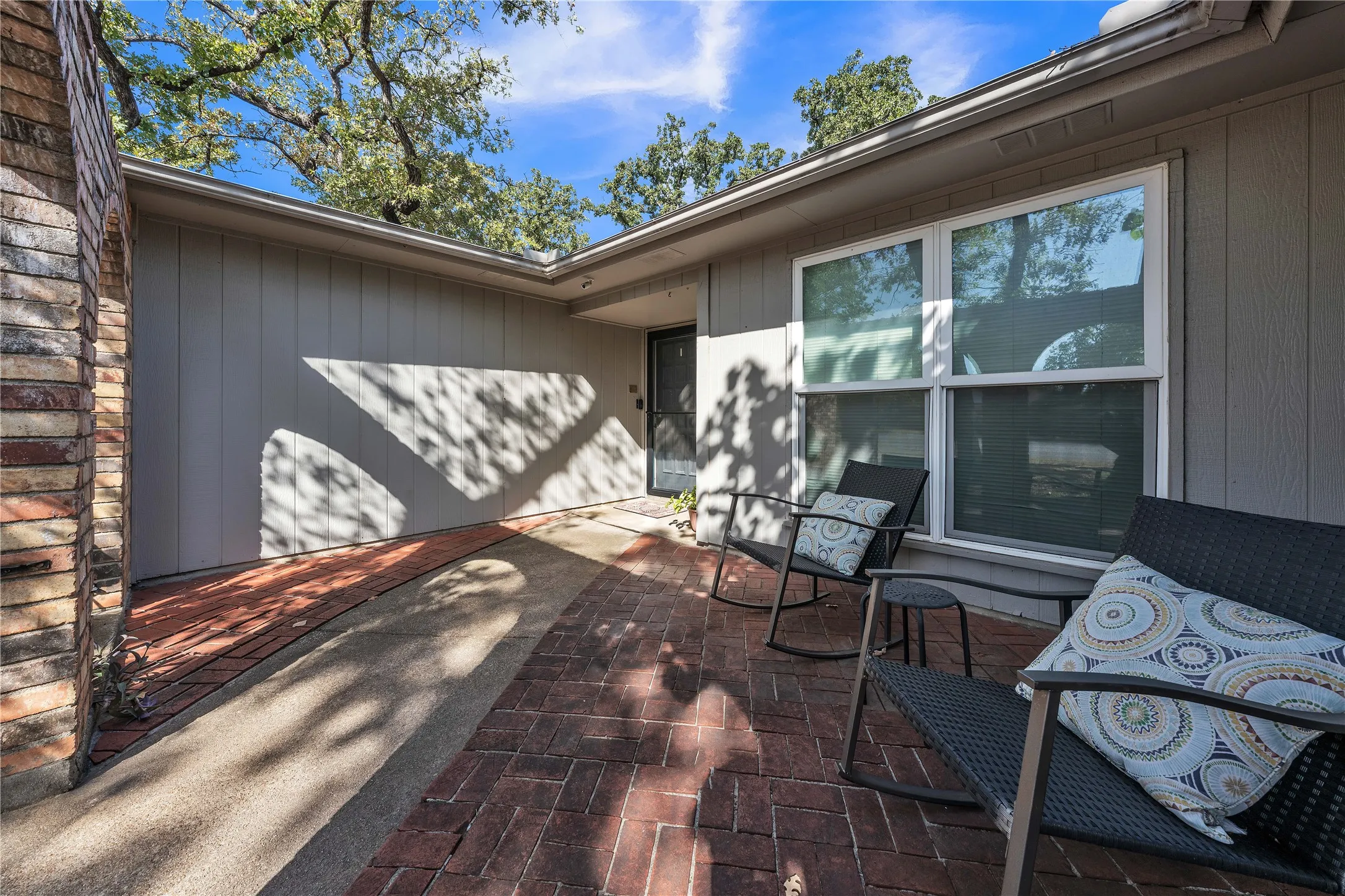 Brick paver patio with a brick column and panel siding