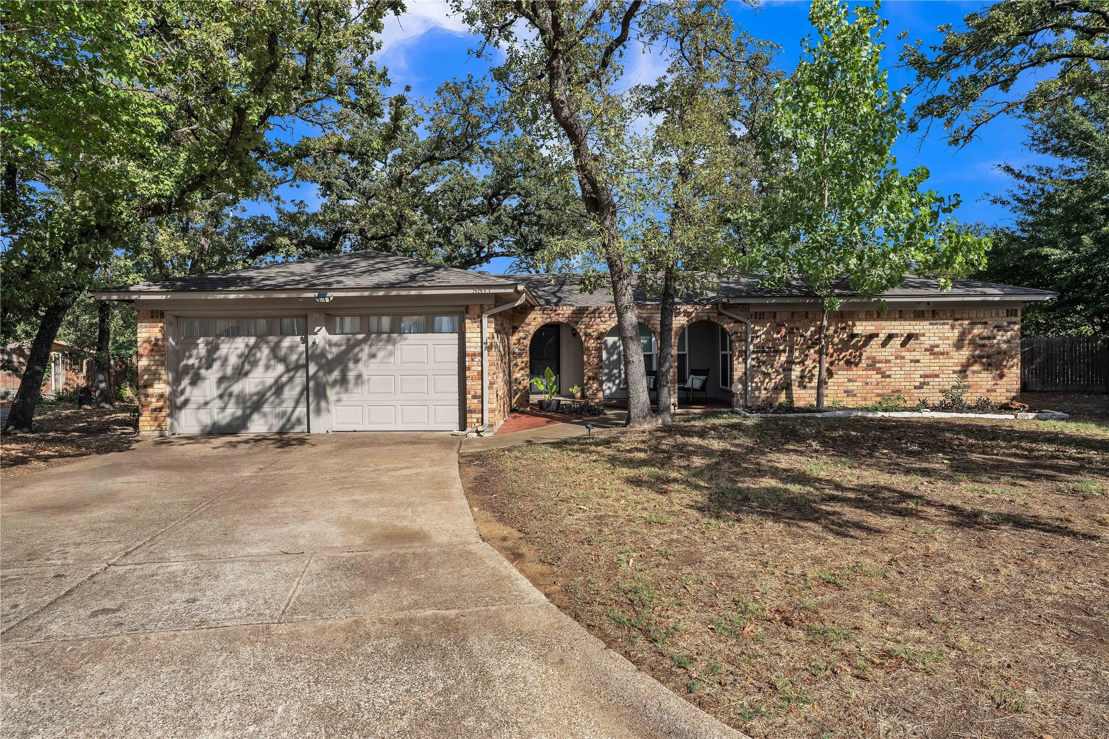 Brick exterior with a gabled roof and a two-car garage