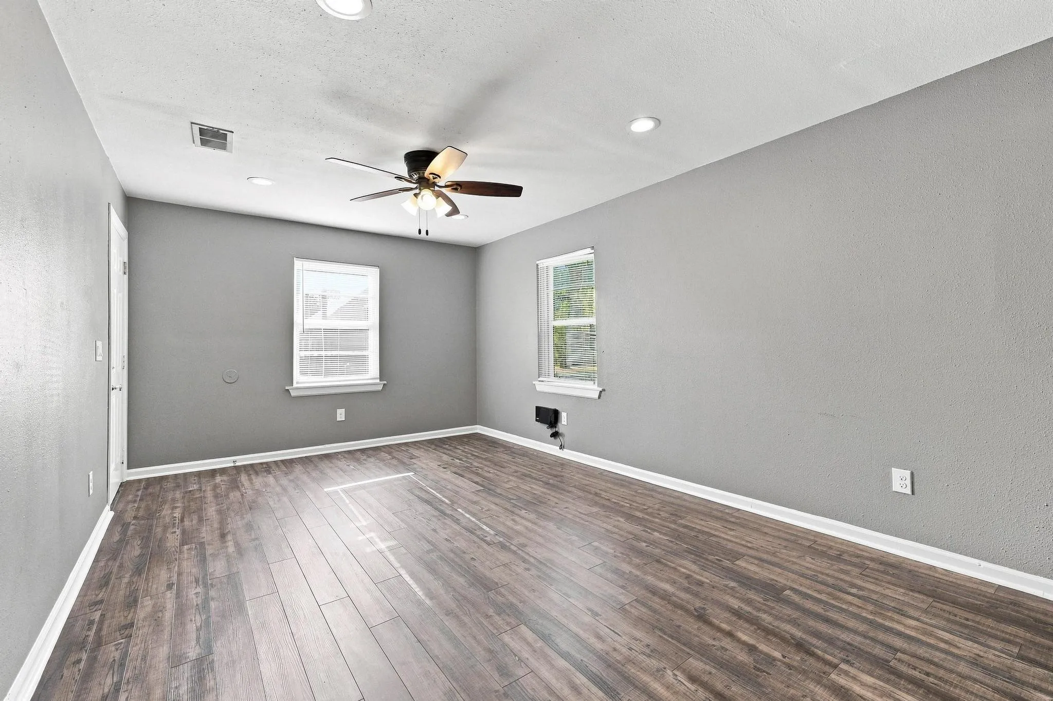 Wood-finish flooring, recessed lighting, and a ceiling fan