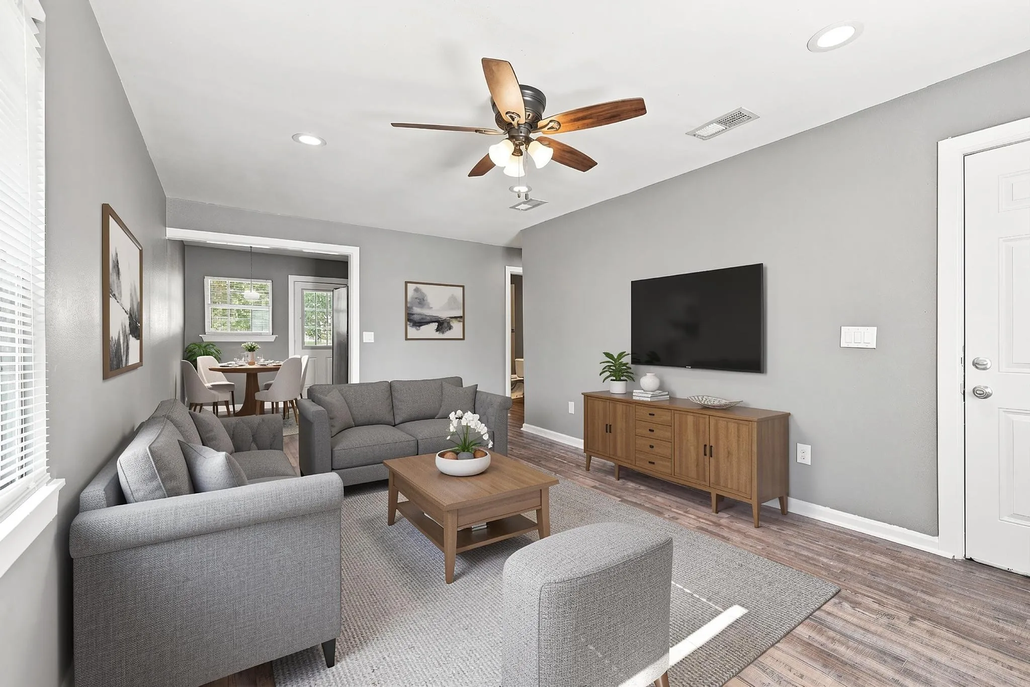 Recessed lighting, wood-finish flooring, ceiling fan with light fixture, and a white paneled door