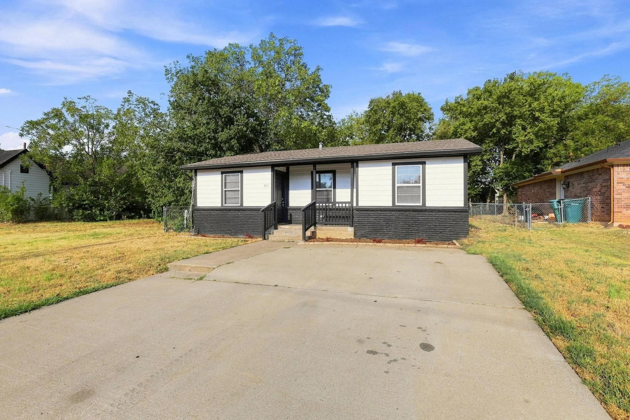 Single-story residence featuring a two-tone exterior, asphalt shingle roof, and a concrete driveway