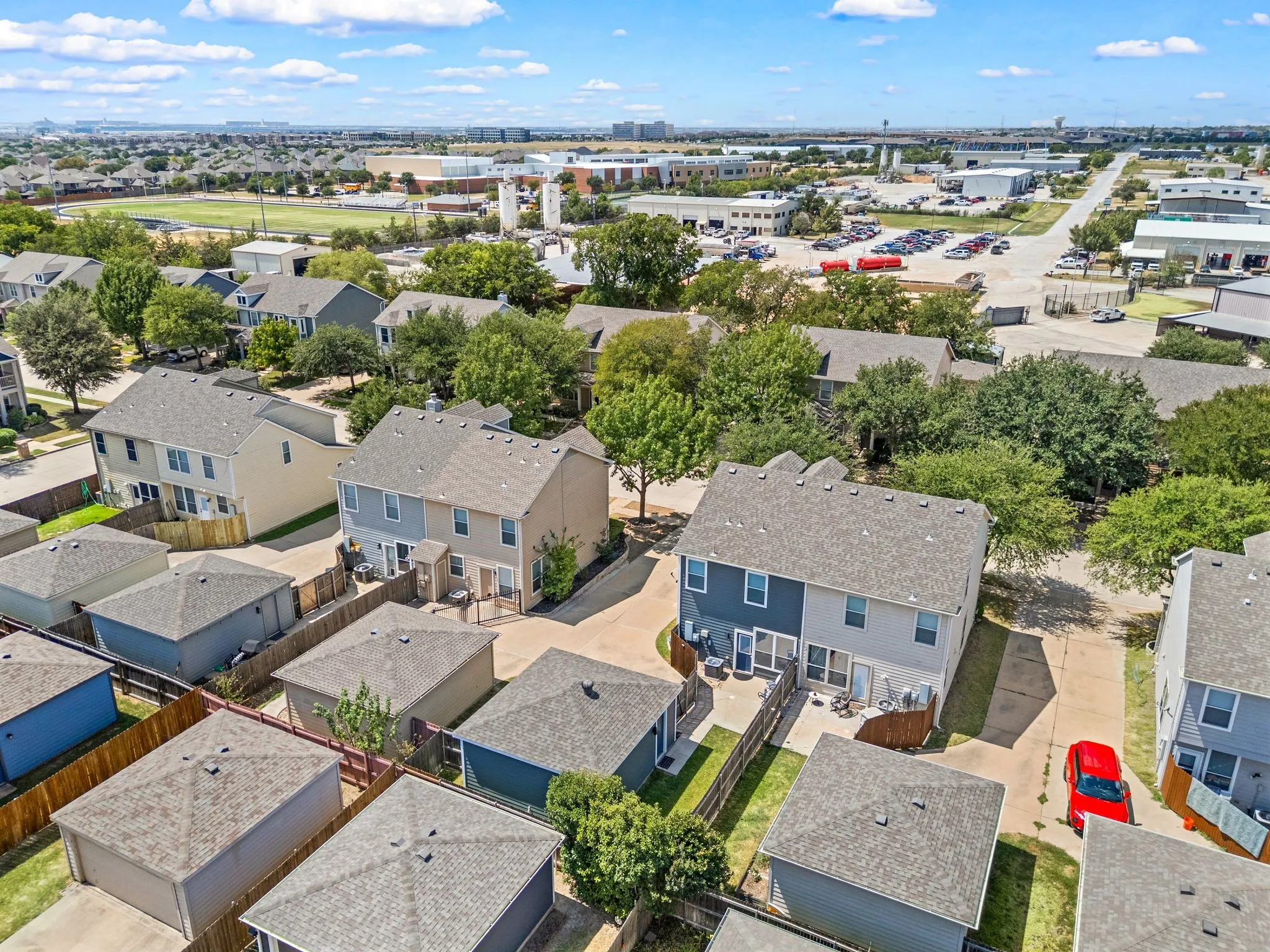 Two-story residential structures with private fenced yards and concrete patios