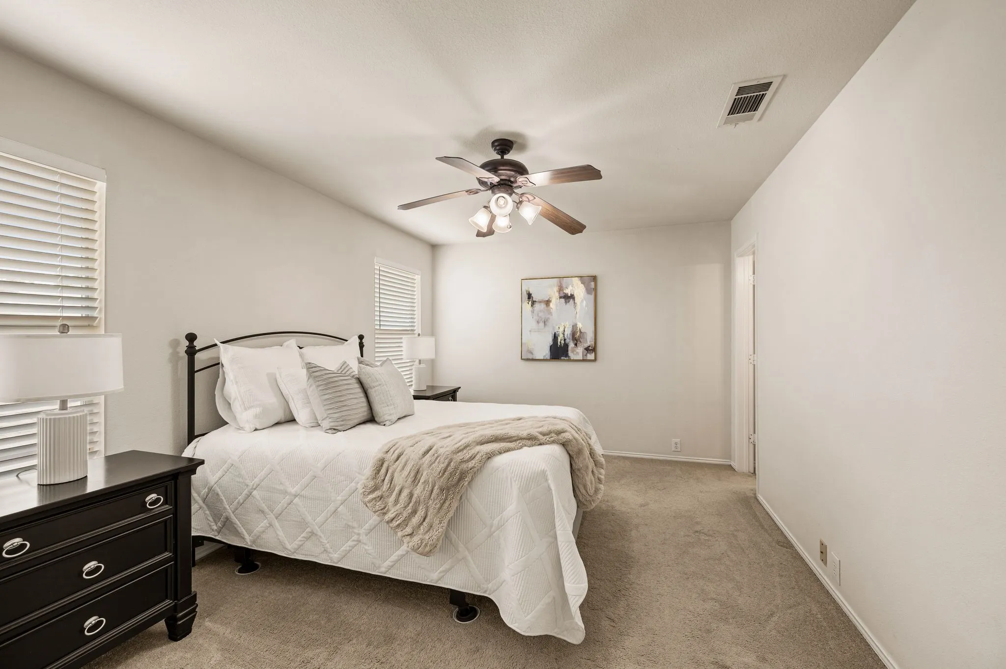 Neutral-toned carpeting, ceiling fan with integrated lighting, window blinds, and light-colored walls